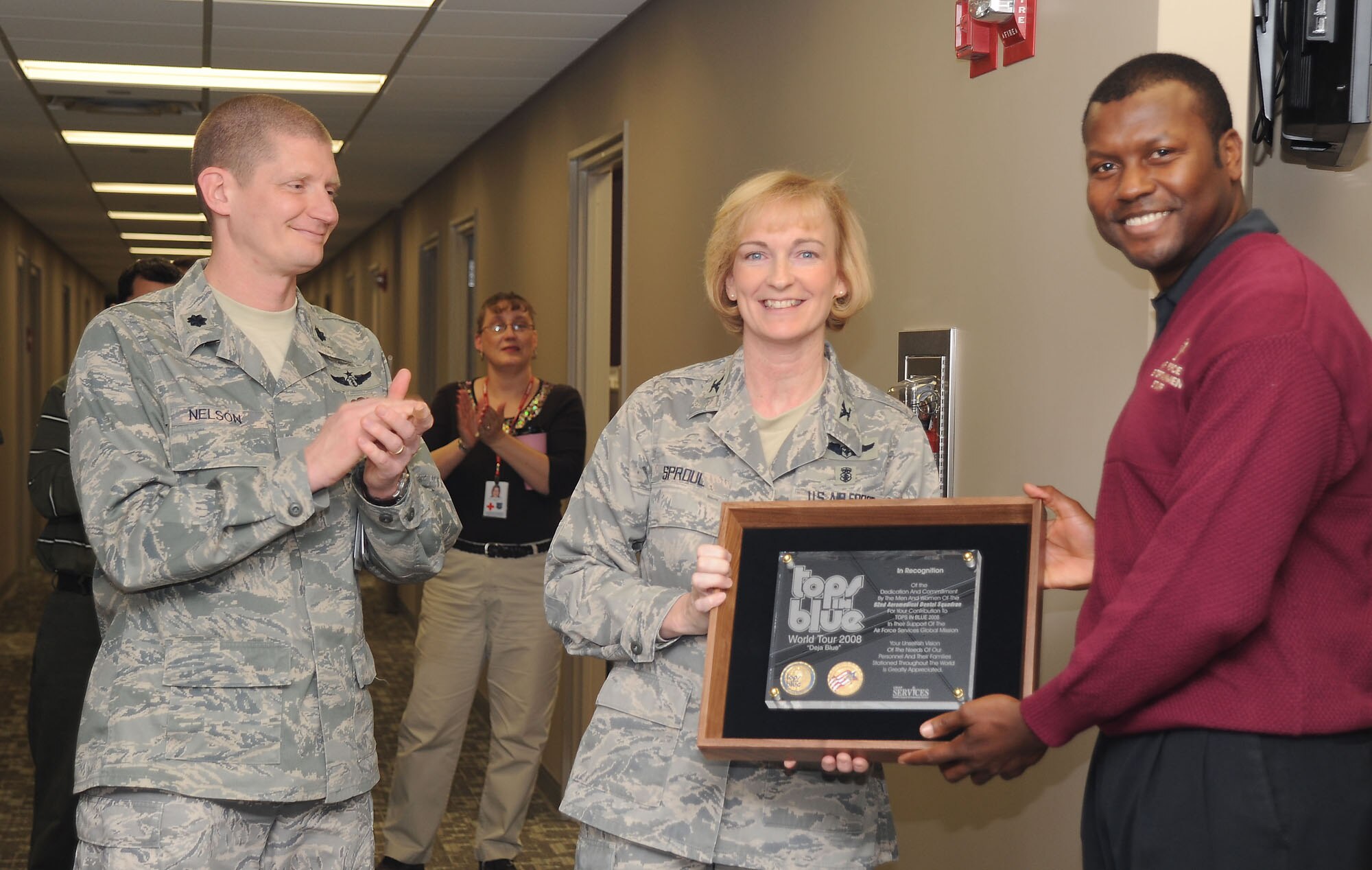 FAIRCHILD AIR FORCE BASE, Wash. – Col. Anne Sproul, 92nd Medical Group commander, accepts a plaque in recognition and appreciation for allowing Senior Airman Cristy Lagazo, a 92nd Aeromedical Dental Squadron public health journeyman, the opportunity to travel with Tops in Blue for their World Tour 2008 titled Deja Blue at Fairchild’s Public Health Office Dec. 3. Units that allow personnel to join the prestigious group are short staffed during the length of the tour. (U.S. Air Force photo / Staff Sgt. JT May III)