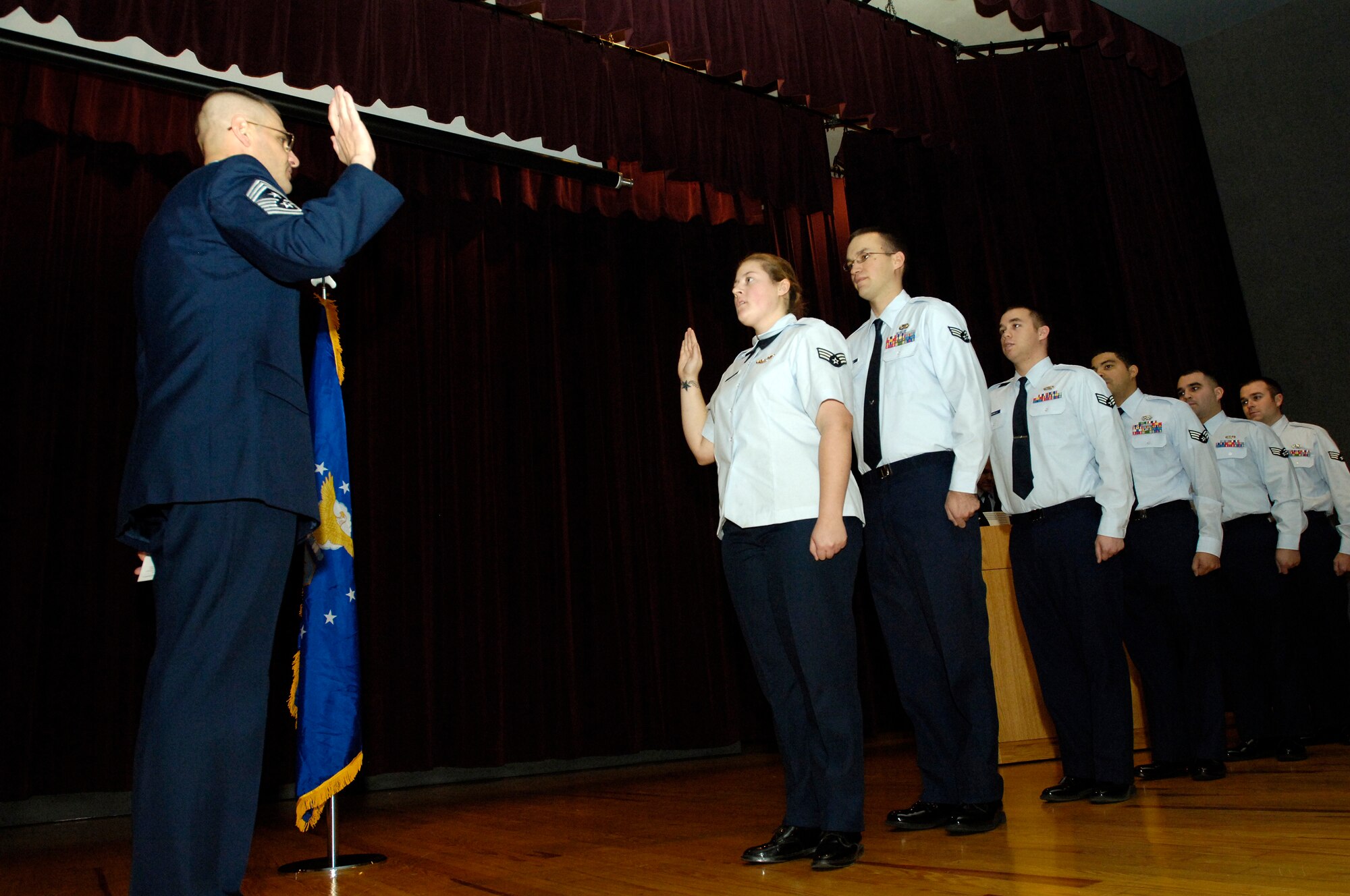 FAIRCHILD AIR FORCE BASE, Wash. – Chief Master Sgt. David Nordel, 92nd Air Refueling Wing command chief, leads Airmen as they repeat their oath of enlistment during the Wing Promotion Ceremony at Club Fairchild Nov. 26. The Airmen repeat their oath of enlistment as a reminder of their commitment to their country while serving in the armed forces. (U.S. Air Force photo / Senior Airman Eunique Stevens)