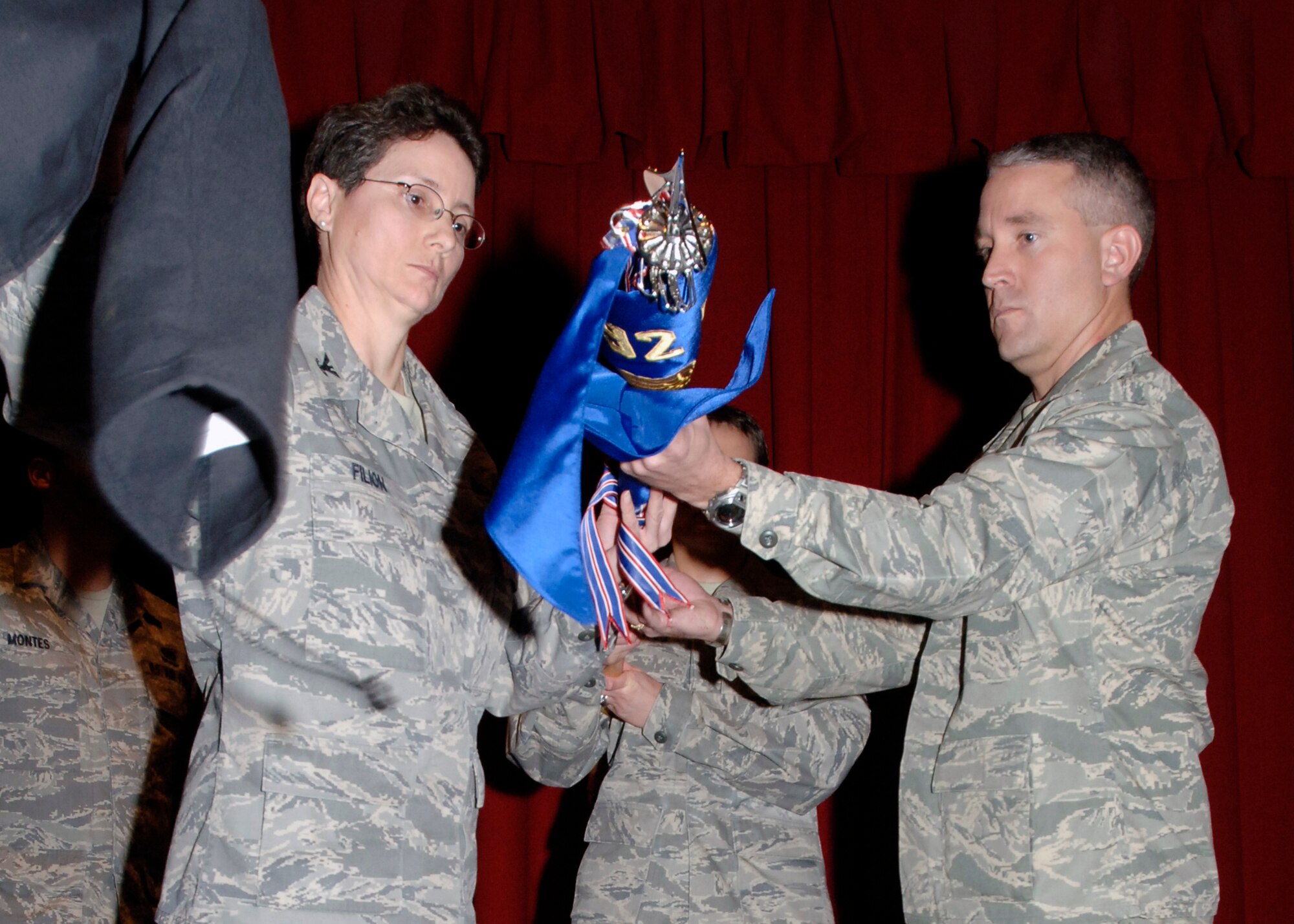 FAIRCHILD AIR FORCE BASE, Wash. – Col. Suzzane Filion, 92nd Mission Support Group commander, and Maj. Jason Knight, 92nd Force Support Squadron commander, unveil the new 92nd FSS Guideon during the 92nd Mission Support Squadron and Services Squadron Merging Ceremony Dec. 2. The merger combines both squadrons under one new command. (U.S. Air Force photo / Airman 1st Class Melissa L. Barnett)
