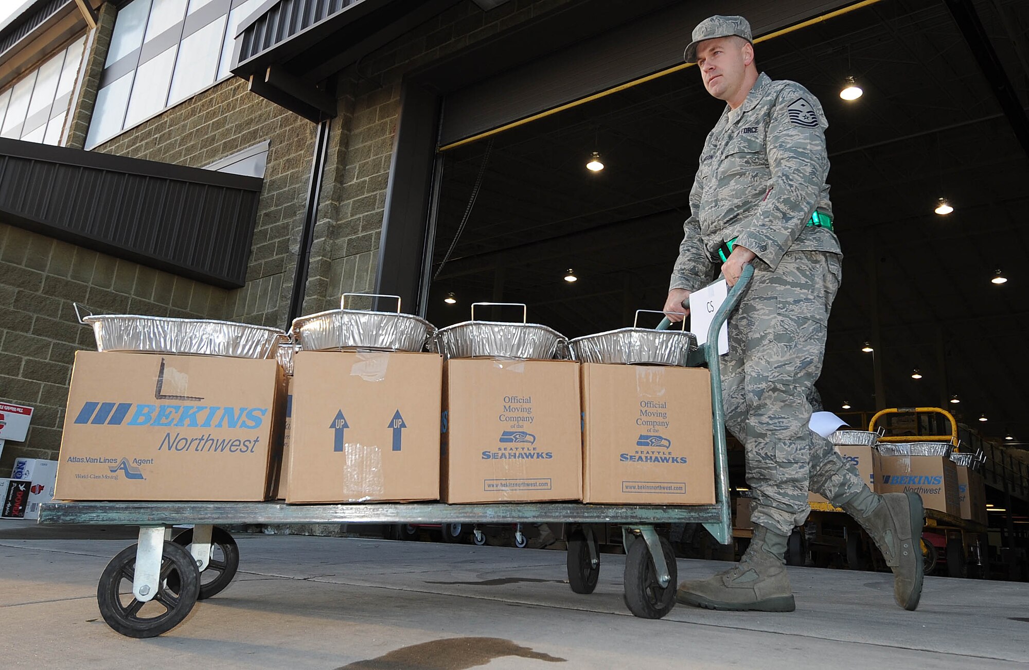 FAIRCHILD AIR FORCE BASE, Wash. –Master Sgt. Robert Swanson, 92nd Communication Squadron first sergeant, hauls Operation Warm Heart boxes to awaiting vehicles. The event took place at the 92nd Logistics Readiness Squadron warehouse on Nov. 21.The boxes were filled with a complete Thanksgiving meal and arranged in two sizes accommodating various family sizes. The funding from this project came solely from yearly fundraising efforts of the Fairchild First Sergeants Council.(U.S. Air Force photo / Staff Sgt. JT May III) 