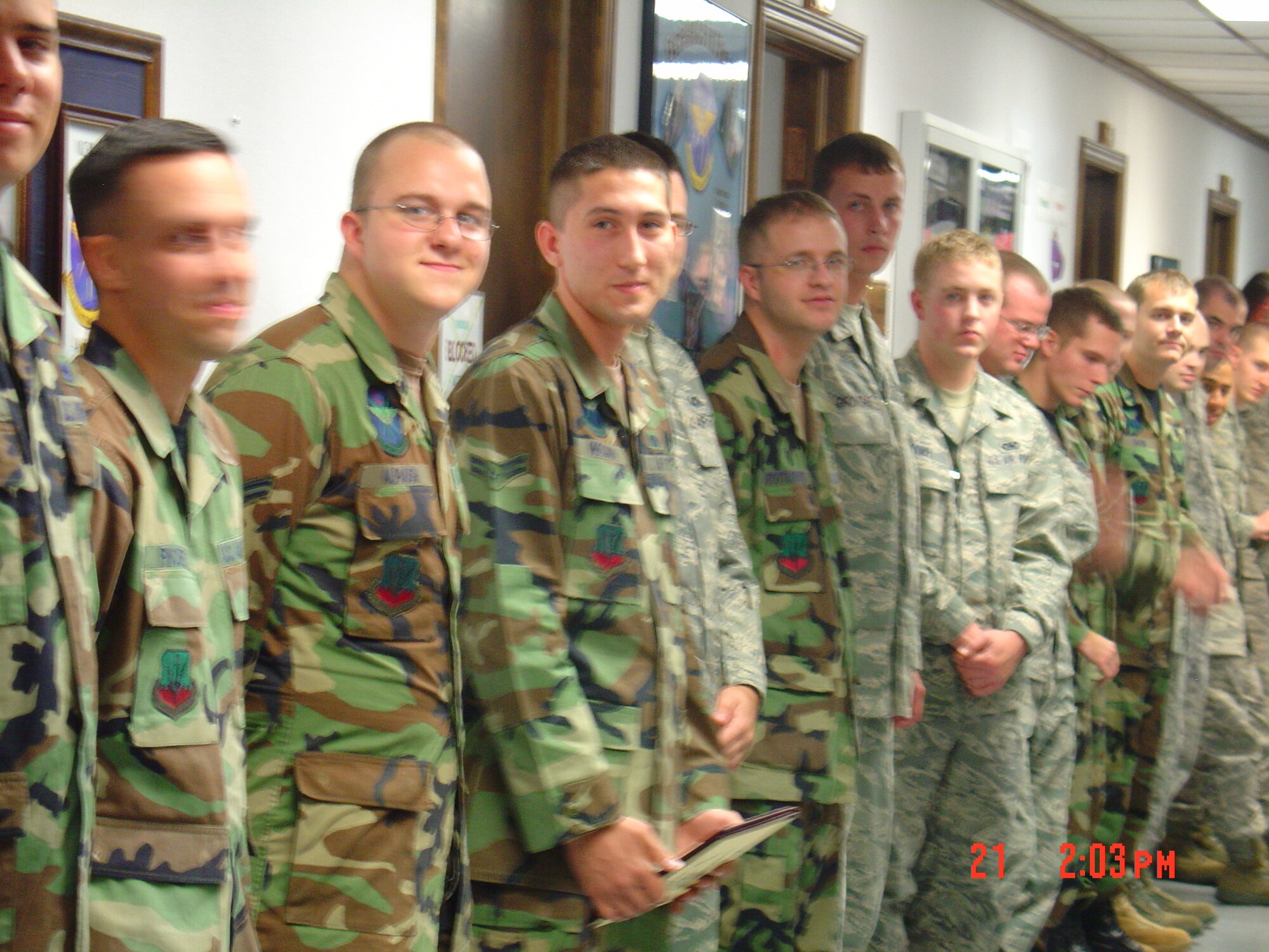 Airman First Class Taj Preciado, 552nd Air Control Networks Squadron, is congratulated at a squadron hall call for winning the grand prize of two-thousand dollars in a Park University essay contest. Photo courtesy of Ms. Vikki Powell, Park University Campus Center Director.