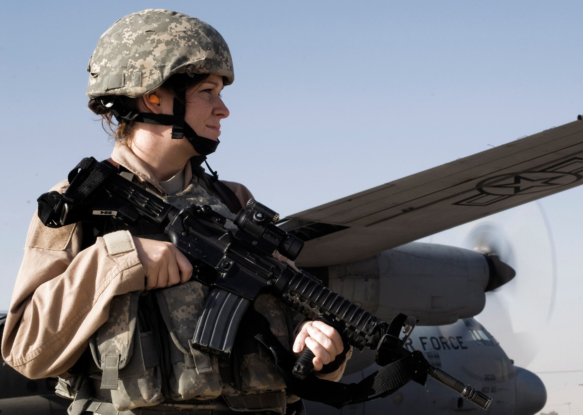 Senior Airman Michelle Kendall scans the area while providing ground security for a 777th Expeditionary Airlift Squadron C-130 Hercules Nov. 22 at a remote location in Iraq. Airman Kendall is a member of a 332nd Expeditionary Security Forces Squadron Fly Away Security Team. She is deployed from Andrews Air Force Base, Md., and her hometown is Houston, Pa. (U.S. Air Force photo/Tech. Sgt. Erik Gudmundson) 

