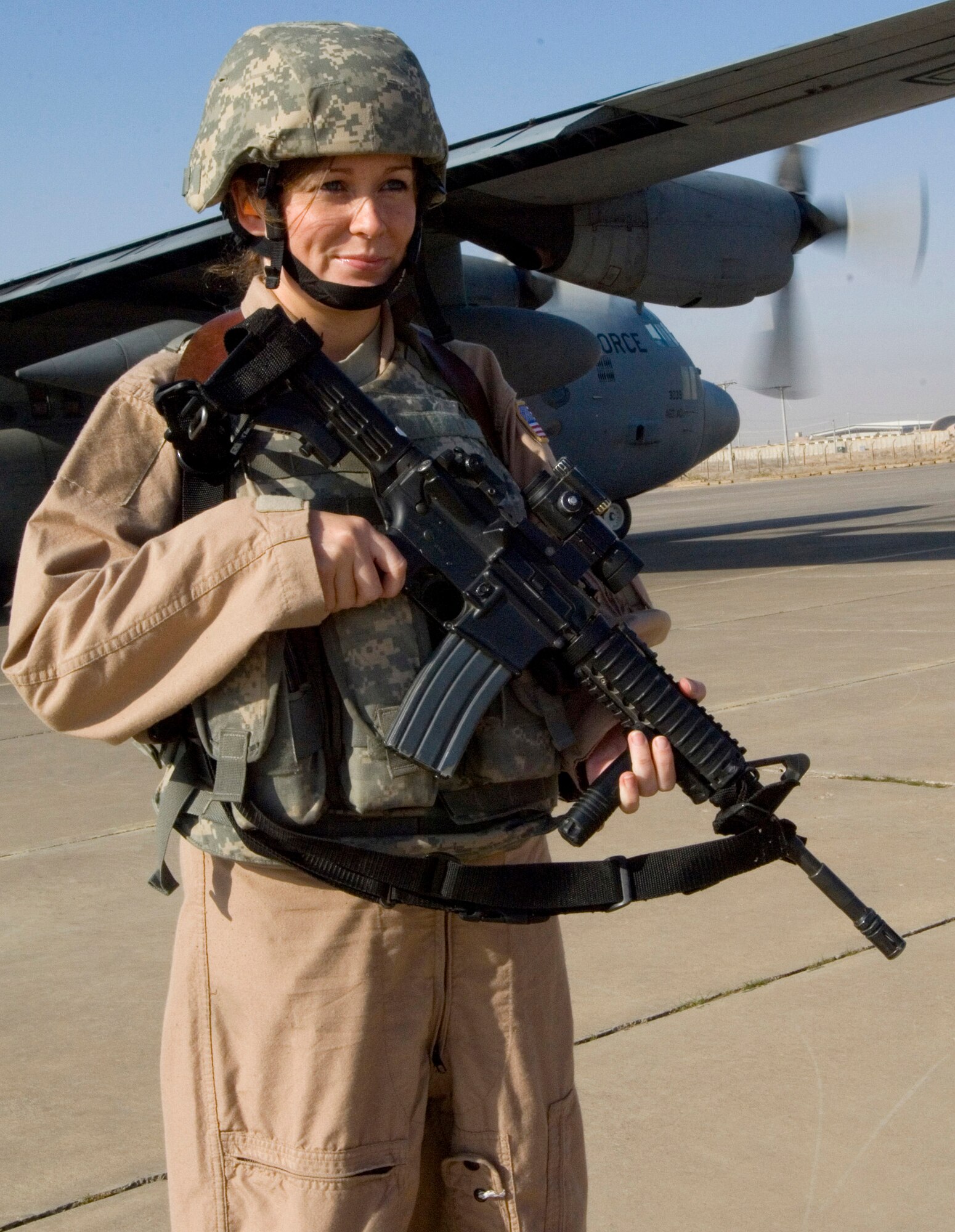 Senior Airman Michelle Kendall scans the area while providing ground security for a 777th Expeditionary Airlift Squadron C-130 Hercules Nov. 22 at a remote location in Iraq. Airman Kendall is a member of a 332nd Expeditionary Security Forces Squadron Fly Away Security Team. She is deployed from Andrews Air Force Base, Md., and her hometown is Houston, Pa. (U.S. Air Force photo/Tech. Sgt. Erik Gudmundson) 
