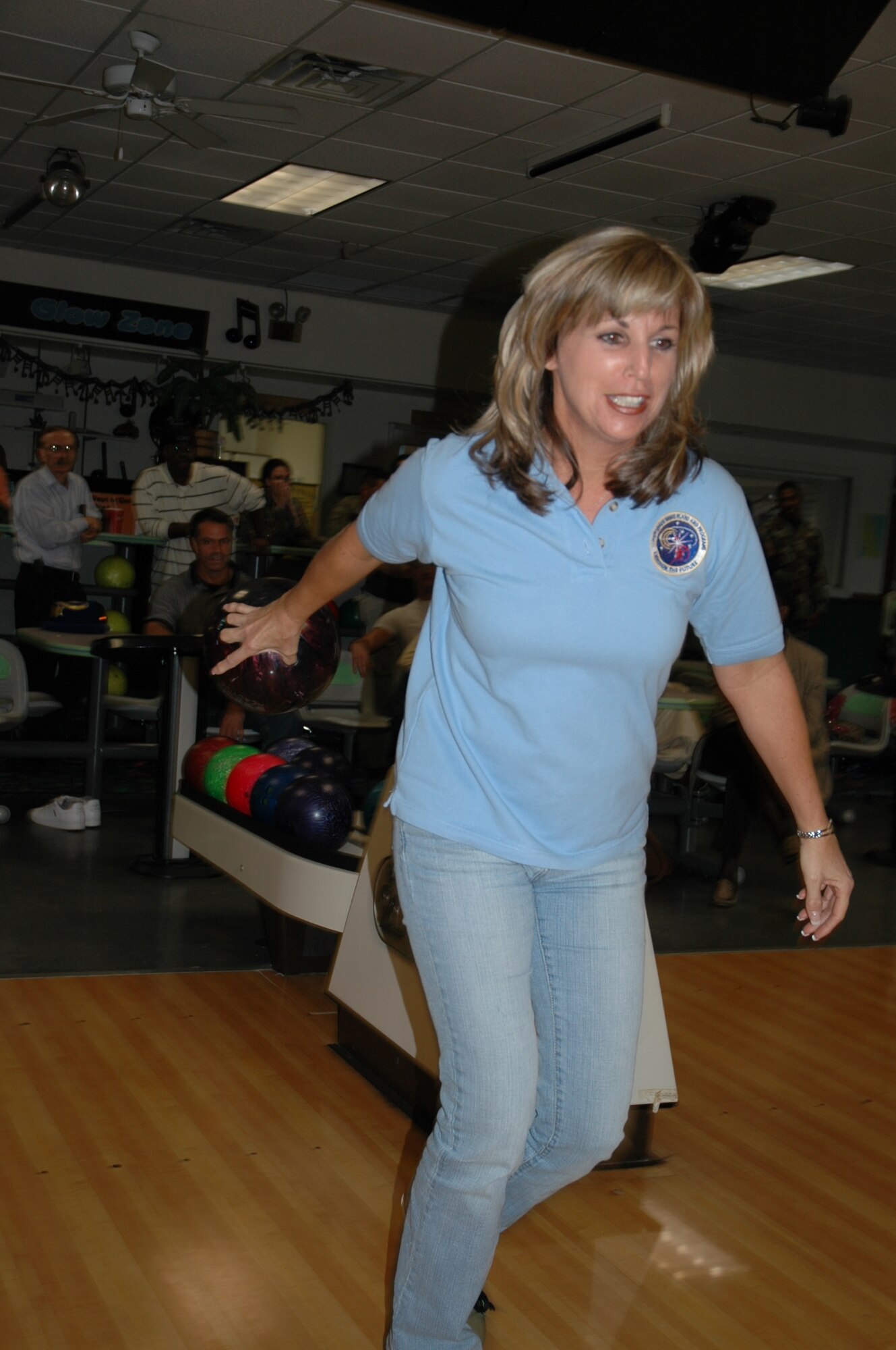 Catherine Wager, from the 45th Space Wing Plans & Programs office, takes dead aim at the ten pins where she hopes to throw a strike in the Rocket Lanes Bowling Center during Patrick Air Force Base and Cape Canaveral Air Force Station’s inaugural Wingman Day Nov. 25. (U.S. Air Force photo by Chris Calkins)