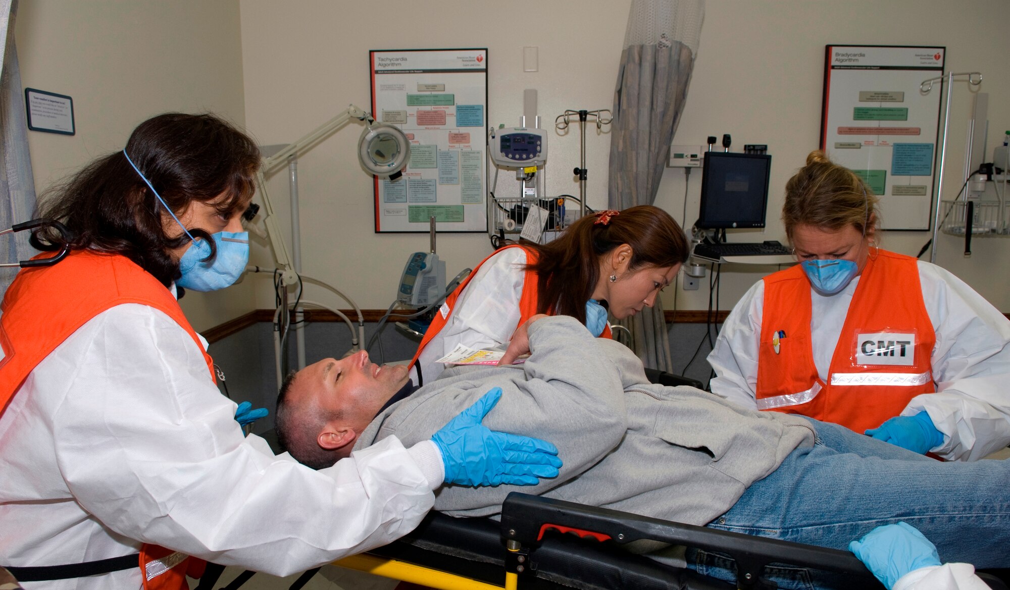 45th Medical Group workers carefully check out the medical conditions of a “victim” before deciding on what actions to take during Patrick Air Force Base's antiterrorism exercise Dec. 2. (U.S. Air Force photo by Jim Laviska)