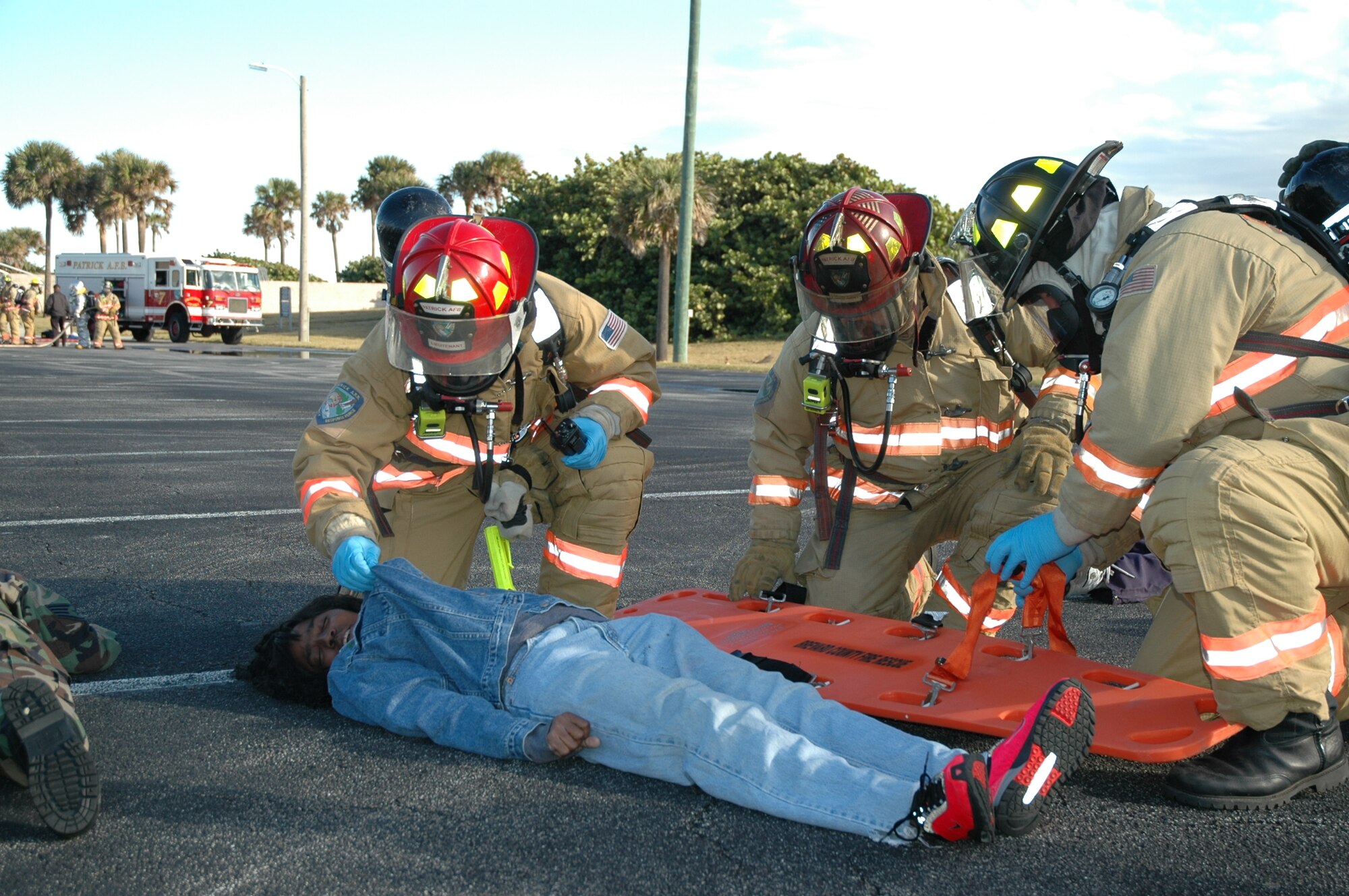 Staff Sgt. Arletha Lewis portrays a casualty of a chemical attack as firemen from the Patrick Fire Department act as first responders during the weeklong Anti-Terrorism Exercise held Dec. 1-5 on Patrick Air Force Base. (U.S. Air Force photo by Jim Laviska)