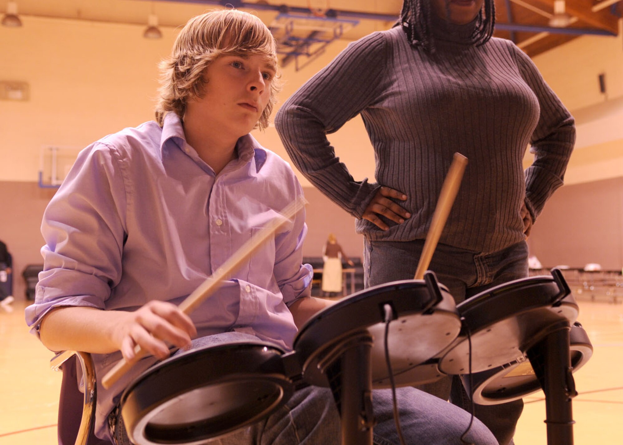 Brad Dewlen, 15, son of Maj. Kenneth Dewlen from the 100th Force Support Squadron, plays video game drums during “Family Fun Night” held at the Youth Center Nov. 21, 2008, at RAF Mildenhall, England. The event was held to get families together for a night of fun. (U.S. Air Force photo by Staff Sgt. Jerry Fleshman)