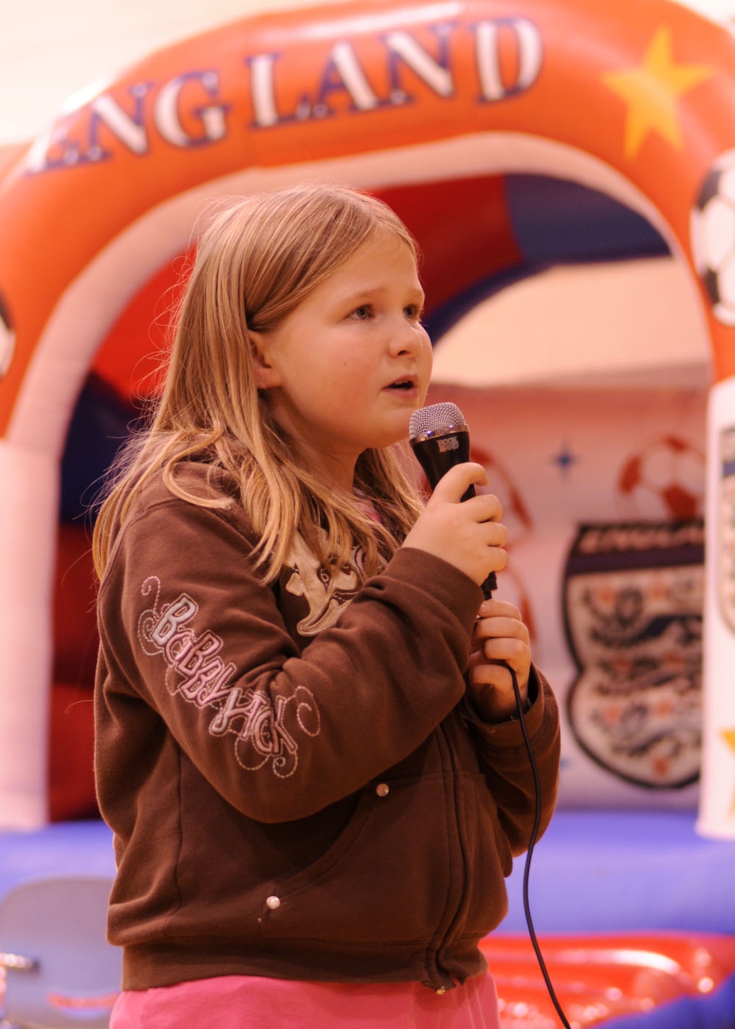 Jewlia Dewlen, 10, daughter of Maj. Kenneth Dewlen from the 100th Force Support Squadron, sings along with a video game during “Family Fun Night” held at the Youth Center Nov. 21, 2008, at RAF Mildenhall, England. The event was held to get families together for a night of fun. (U.S. Air Force photo by Staff Sgt. Jerry Fleshman)