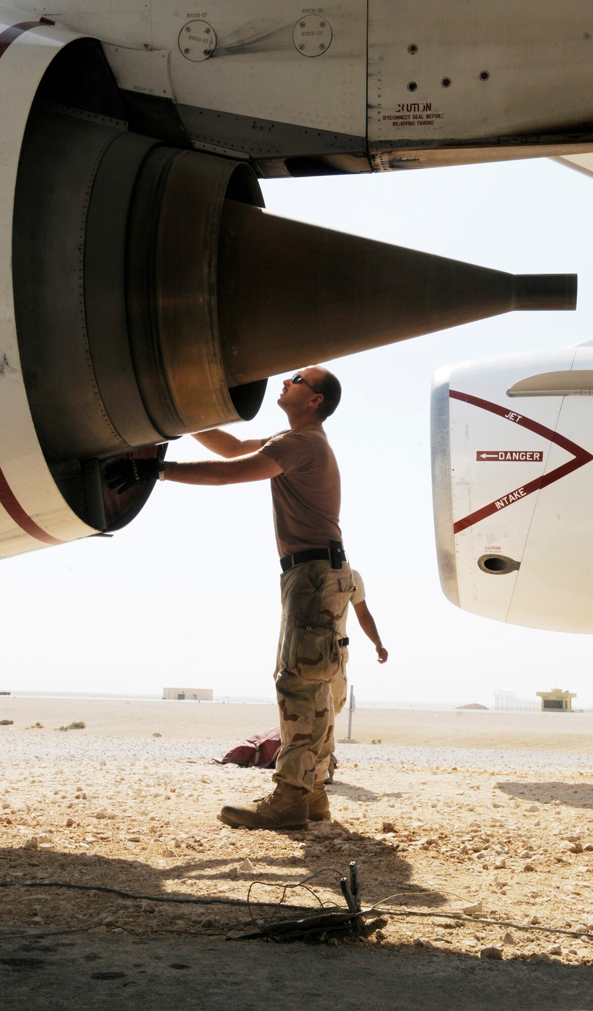 Petty Officer 2nd Class Clyde Ramsay, an aviation machinist mate assigned to Task Force 124, places covers in the E-6B Mercury airborne command post engine air outlets at an undisclosed base in Southwest Asia, Nov. 26, 2008. The unit uses only one aircraft to support radio communications in the area of responsibility. The TACAMO (Take Charge And Move Out) unit has handled more than 15,300 tactical support calls since October 2006. (U.S. Air Force photo by Tech. Sgt. Michael Boquette)