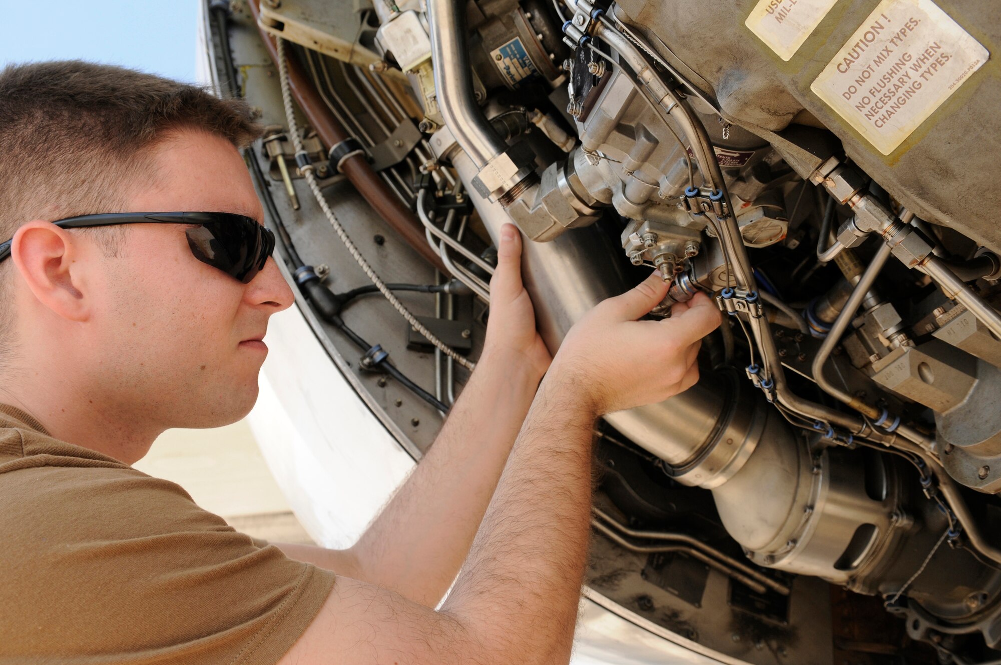 Petty Officer 2nd Class Joseph Henricks, an aviation electronics mate assigned to Task Force 124 or TACAMO (Take Charge And Move Out), inspects  a hydraulic pump cannon plug on an E-6B Mercury airborne  command post at an undisclosed base in Southwest Asia, Nov. 26, 2008. The TACAMO unit's technicians use an Army system called the Joint Airborne Communication Suite to ensure communications in areas where radio transmissions are most difficult.  Petty Officer Henricks is a native of Littleton, Ill., and is deployed from Tinker Air Force Base, Okla., in support of operations Iraqi and Enduring Freedom. (U.S. Air Force photo by Tech. Sgt. Michael Boquette) 