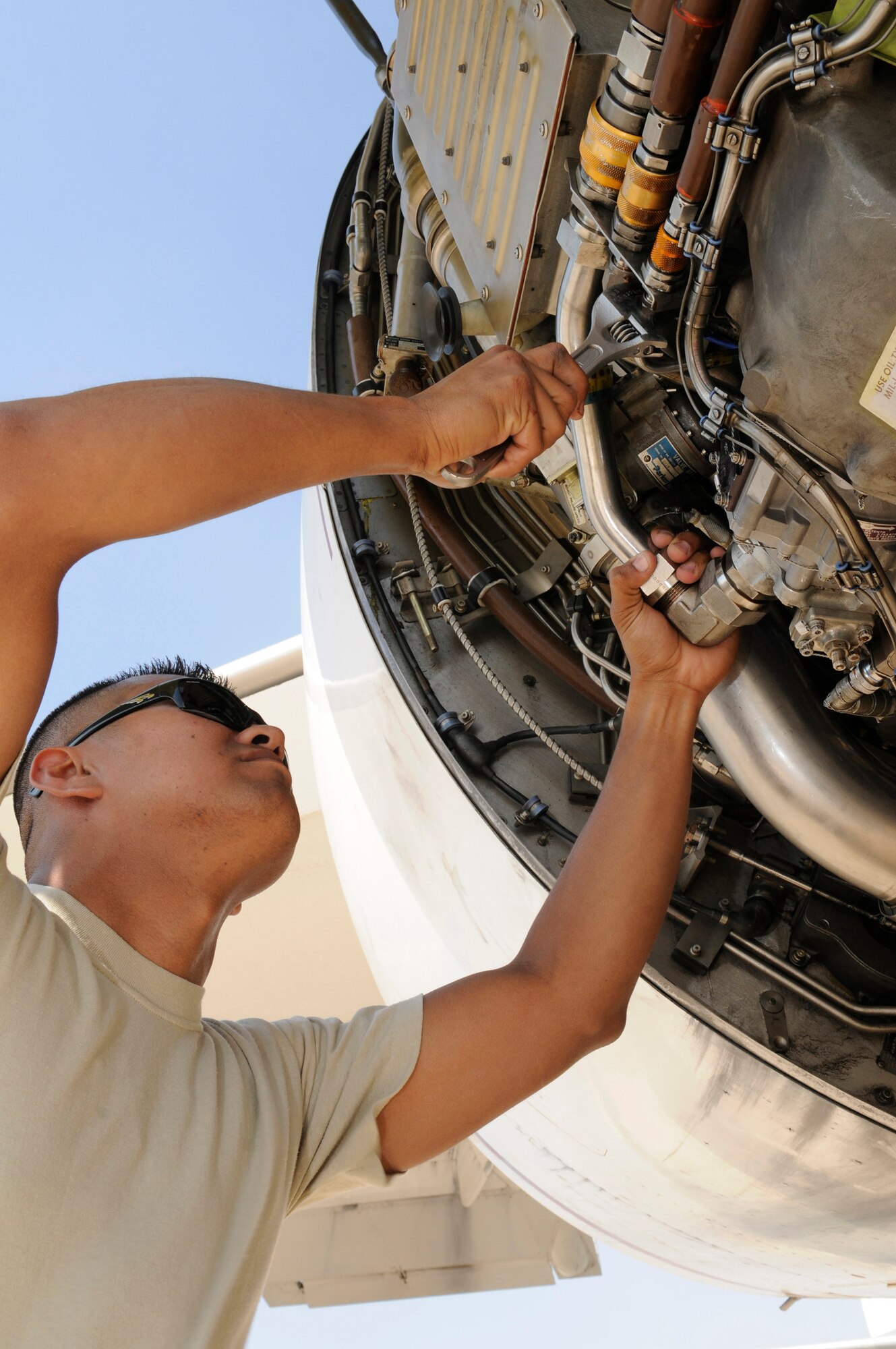 Petty Officer 2nd Class Luis Restrepo, an aviation structural mechanic assigned to Task Force 124 or TACAMO (Take Charge And Move Out), tightens the connections on a hydraulic pump on his E-6B Mercury airborne  command post at an undisclosed base in Southwest Asia, Nov. 26. The TACAMO unit's technicians use an Army system called the Joint Airborne Communication Suite to ensure communications in areas where radio transmissions are most difficult.  Petty Officer Restrepo is a native of Union City, N.J., and is deployed from Tinker Air Force Base, Okla. (U.S. Air Force photo by Tech. Sgt. Michael Boquette)