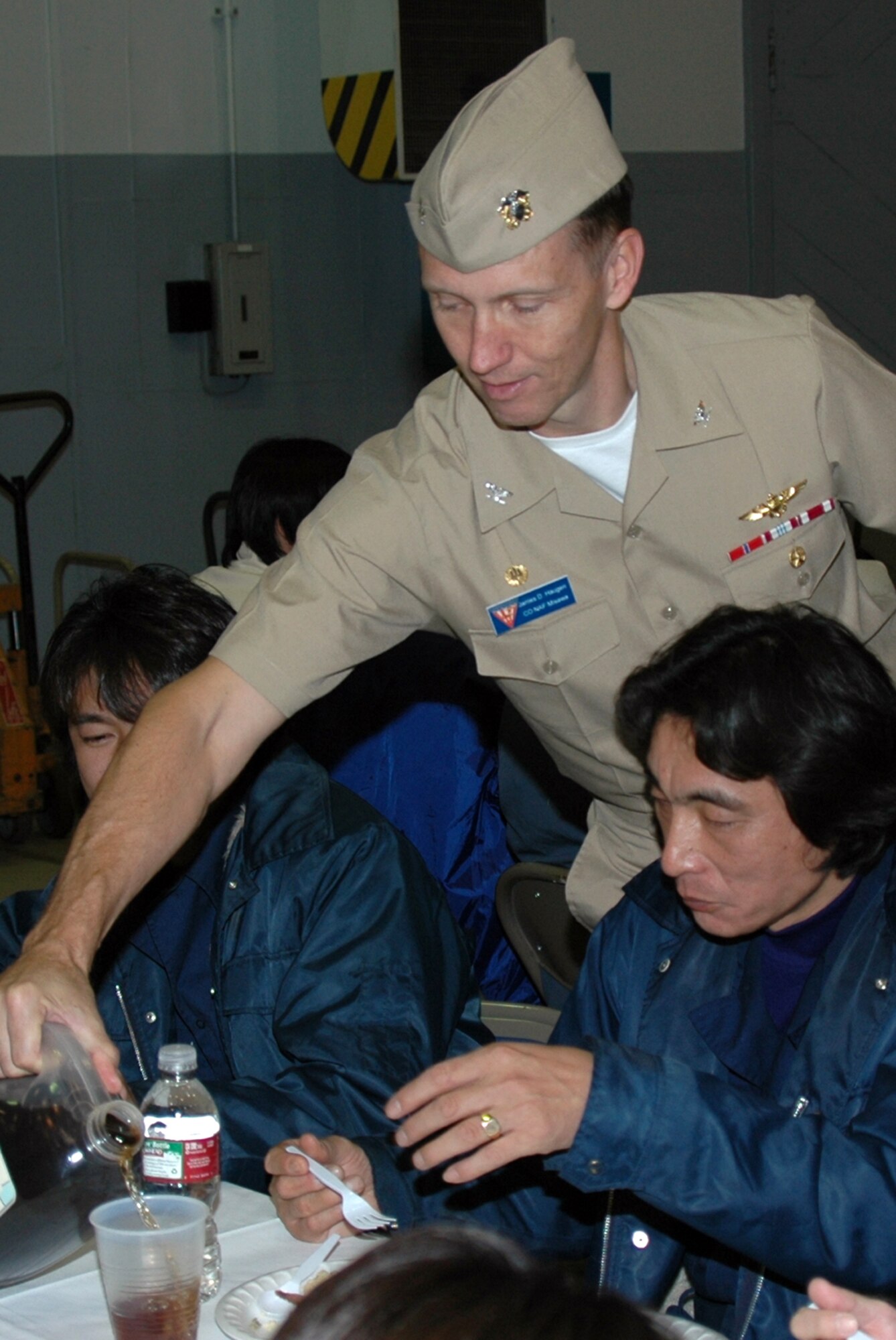 MISAWA AIR BASE, Japan -- Navy Capt. J.D. Haugen, Naval Air Facility Misawa commander, serves tea to diners during the annual pre-Thanksgiving luncheon held onboard the facility Nov. 21, 2008. The meal is sponsored each year by the chiefs and officers from the command, as a way of showing appreciation to the Sailors and civilians who work there. (U.S. Navy photo by Chief Petty Officer Brian Naranjo)