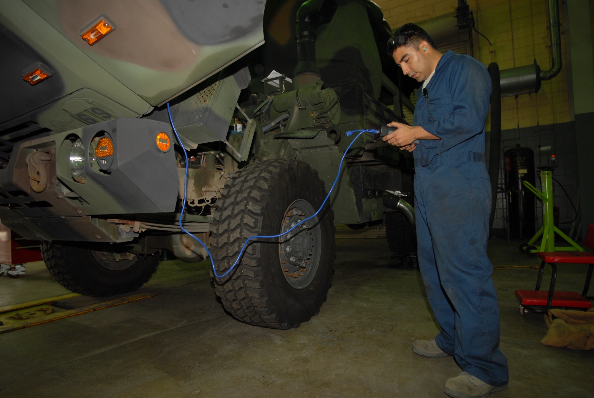 KUNSAN AIR BASE, Republic of Korea -- Staff Sgt. Enrique Lara, 8th Logistic Readiness Squadron, vehicle maintenance craftsman, services the fuel injector of a M1078 A-1 Light Mobile Tactical Vehicle here Dec. 4.The Wolf Pack’s vehicle maintenance Airmen are responsible for keeping more than 600 general and special purpose vehicles operational for the Airmen, Soldiers and civilians assigned to the base. (U.S. Air Force photo by: Senior Airman Angela Ruiz)