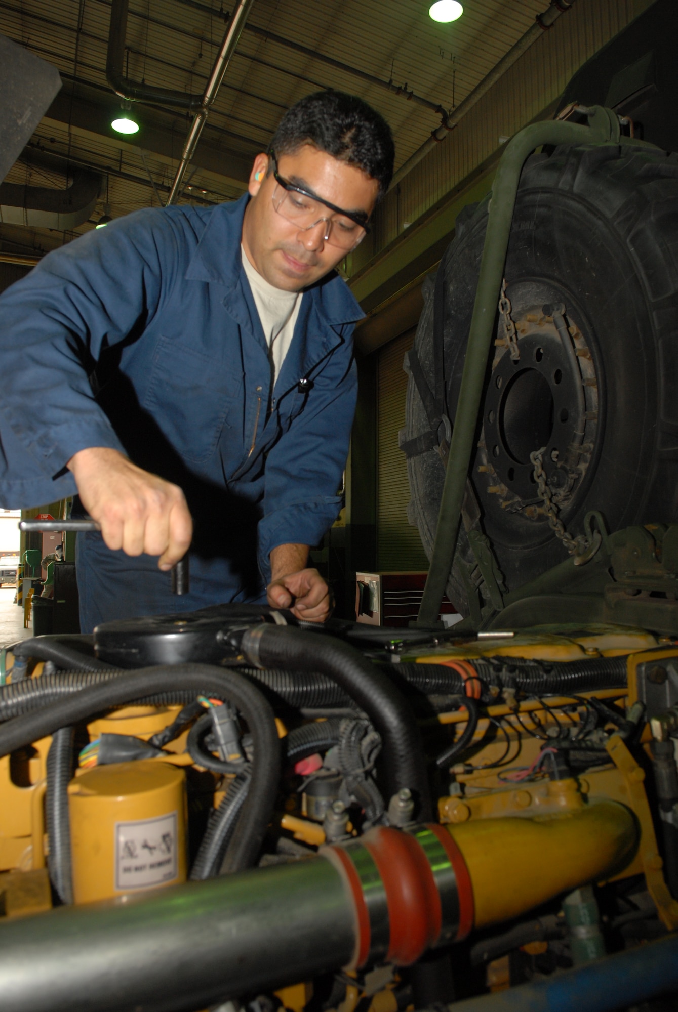 KUNSAN AIR BASE, Republic of Korea -- Staff Sgt. Enrique Lara, 8th Logistics Readiness Squadron, vehicle maintenance craftsman, services the fuel injector of a M1078 A-1 Light Mobile Tactical Vehicle here Dec. 4. The Wolf Pack’s vehicle maintenance Airmen are responsible for keeping more than 600 general and special purpose vehicles operational for the Airmen, Soldiers and civilians assigned to the base. (U.S. Air Force photo by: Senior Airman Angela Ruiz)