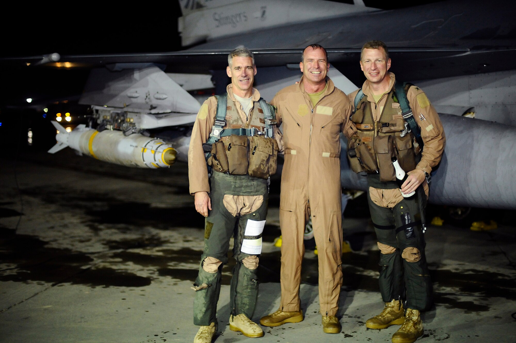 Cols. David Romuald, Michael Fantini and John Dolan pose in front of an F-16 Fighting Falcon at Joint Base Balad, Iraq, after they each completed their 3,000th flying hour in an F-16 Dec. 2. As tradition would dictate, they were hosed down with water from fire department crash trucks after leaving their cockpits. Approximately 150 F-16 F-16 pilots have surpassed the 3,000 hour mark. Dolan is the vice commander of the 332nd Air Expeditionary Wing, Fantini is the commander of the 332nd Expeditionary Operations Group and Romauld is the 332nd Expeditionary Operations Group deputy commander. (U.S. Air Force photo/Airman 1st Class Jason Epley)(Released)