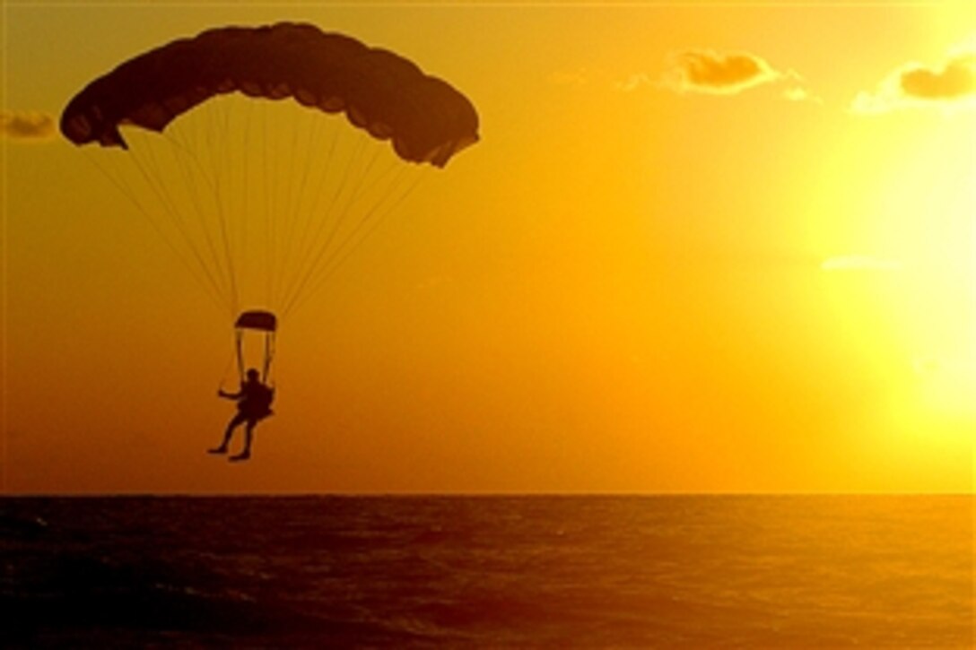 A U.S. Air Force pararescueman prepares to land in the Pacific Ocean after jumping from an MC-130H Combat Talon II, Dec. 2, 2008. The pararescueman was one of seven assigned to the 320th Special Tactics Squadron at Kadena Air Base, Japan, who parachuted into the water to search for survivors'during a simulated aircraft accident exercise.