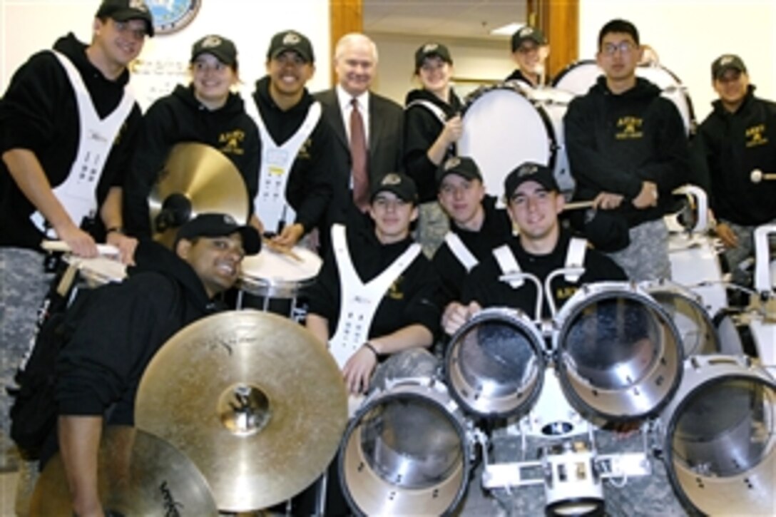 Defense Secretary Robert M. Gates poses with the members of the U.S. Army West Point Pep Band during their tour of the Pentagon, Dec. 5, 2008, in anticipation of the Dec. 6 Army-Navy football game in Philadelphia.