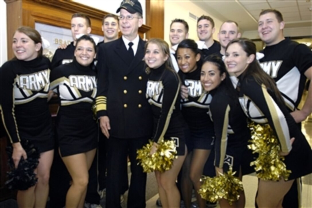 U.S. Navy Adm. Mike Mullen, chairman of the Joint Chiefs of Staff, wears his Army ball cap as he poses for a photo with members of the U.S. Army West Point Pep Band cheerleaders during their tour of the Pentagon, Dec. 5, 2008, in anticipation of the Dec. 6 Army-Navy football game in Philadelphia.