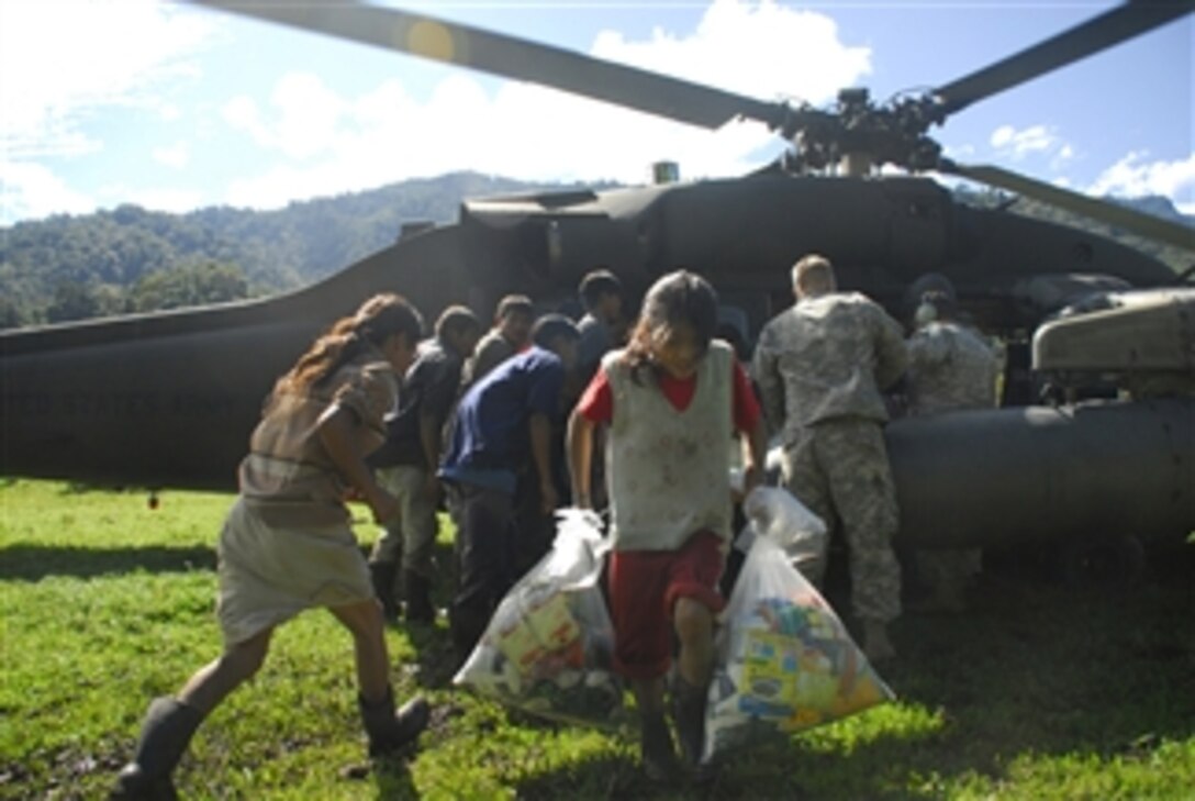 U.S. Army soldiers from Joint Task Force - Bravo distribute food and supplies to residents in a remote village in Costa Rica on Dec. 1, 2008.  U.S. service members are participating in humanitarian disaster relief missions in Costa Rica and Panama after heavy rains caused flooding and landslides in the area.  