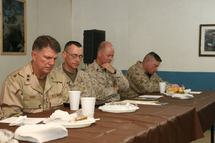 Navy Chief of Chaplains Rear Adm. Robert Burt bows his head in prayer during a prayer breakfast at Camp Ramadi, Iraq, Dec. 5. Service members throughout al Anbar Province were invited to have breakfast with Burt.