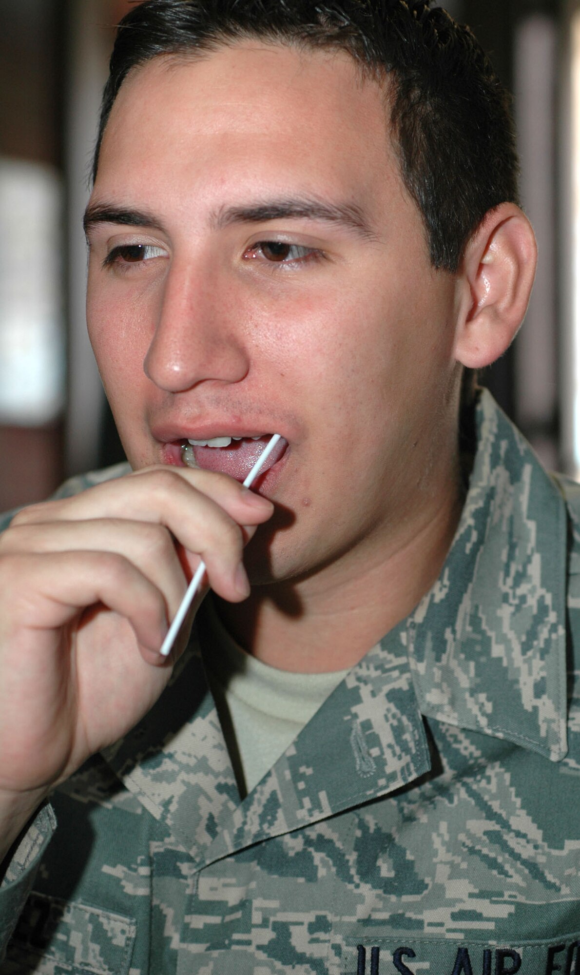 Airman 1st Class Michael Gomez swabs the side of his cheek for DNA samples Dec. 6 while signing up to be a bone marrow donor at the 302nd Airlift Wing's military personnel flight building on Peterson Air Force Base, Colo. Airman Gomez and several other members of the wing volunteered to join the Department of Defense and National Marrow Donor Program's registry. Airman Gomez is an operations management technician with the 302nd Civil Engineer Squadron and is a native of El Paso, Texas. For more on the program, visit www.dodmarrow.org. (U.S. Air Force photo/Senior Airman Stephen Collier)