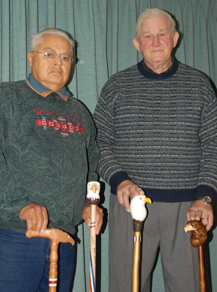 NIAGARA FALLS AIR RESERVE STATION, N.Y. -- Tech. Sgt. (Retired) Ron Kraft (left) and Master Sgt. (Retired) Ron Kurek of the Rainbow Carvers of Lewiston, N.Y. display some of their labor of love.  The group is one of many nationwide that volunteer their time to handcraft these canes for wounded veterans in the local Western New York area. These canes are provided free of charge to any service member who fought in Afghanistan or Iraq, but are also available to any wounded veteran.   (U.S. Air Force Reserve photo by Master Sgt. Peter Borys)