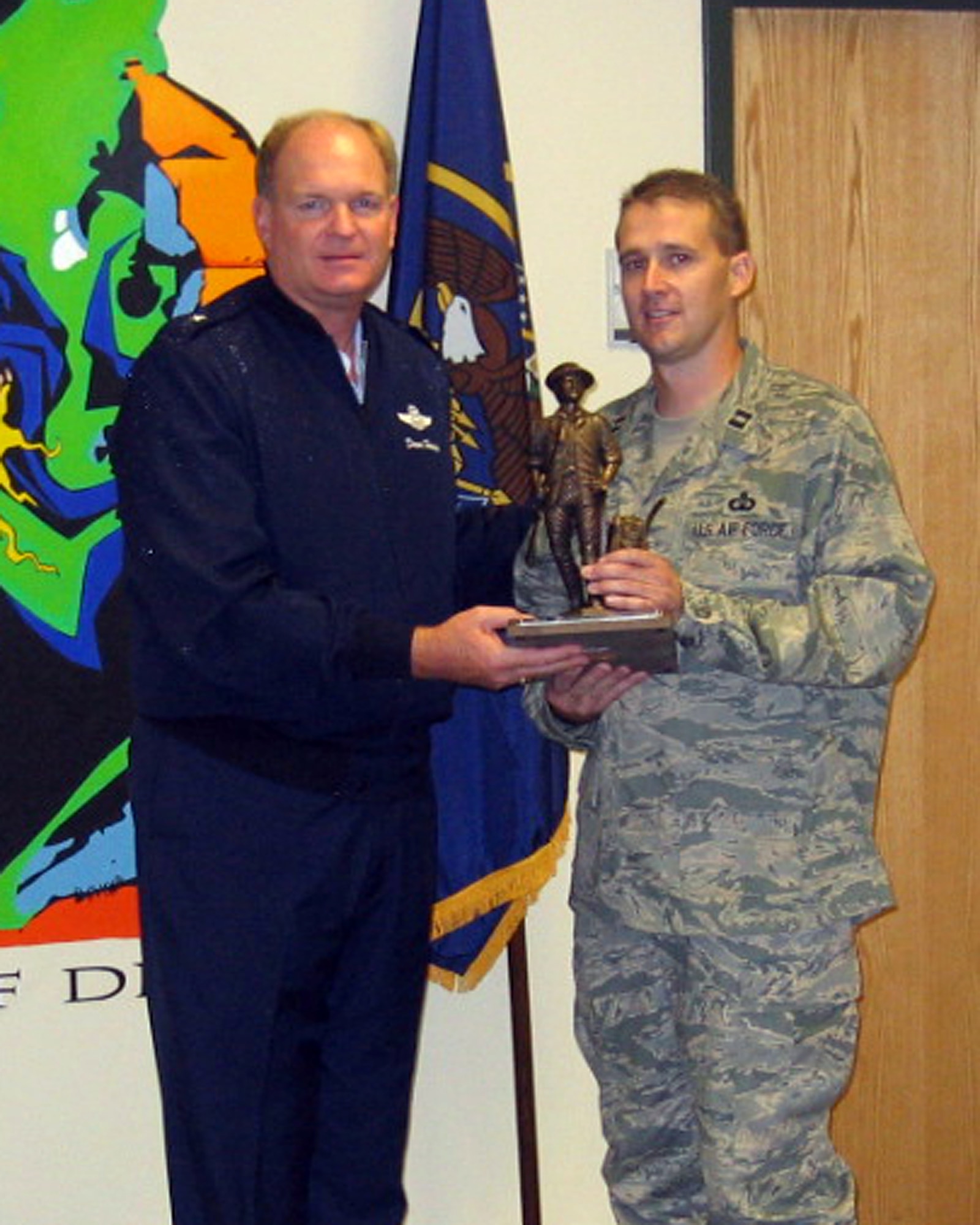 Capt. Todd Lobato, 299th Range Control Squadron, Air Traffic Control Training chief, receives the Outstanding Safety Achievement Award for the Air National Guard from Brig. Gen. David Hooper, Assistant Adjutant General for Air, Utah ANG, in October 2008.  