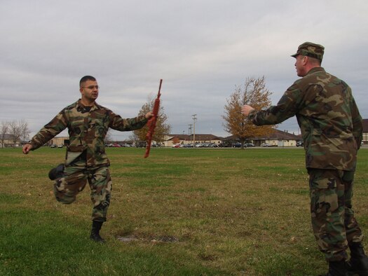 NIAGARA FALLS AIR RESERVE STATION, N.Y. --  Tech. Sgt. Mohammad Ali (left) hands off a training weapon to a fellow Airman during a skills challenge relay race here Nov.1, 2008.  (U.S. Air Force photo by Airman 1st Class Andrew Caya)