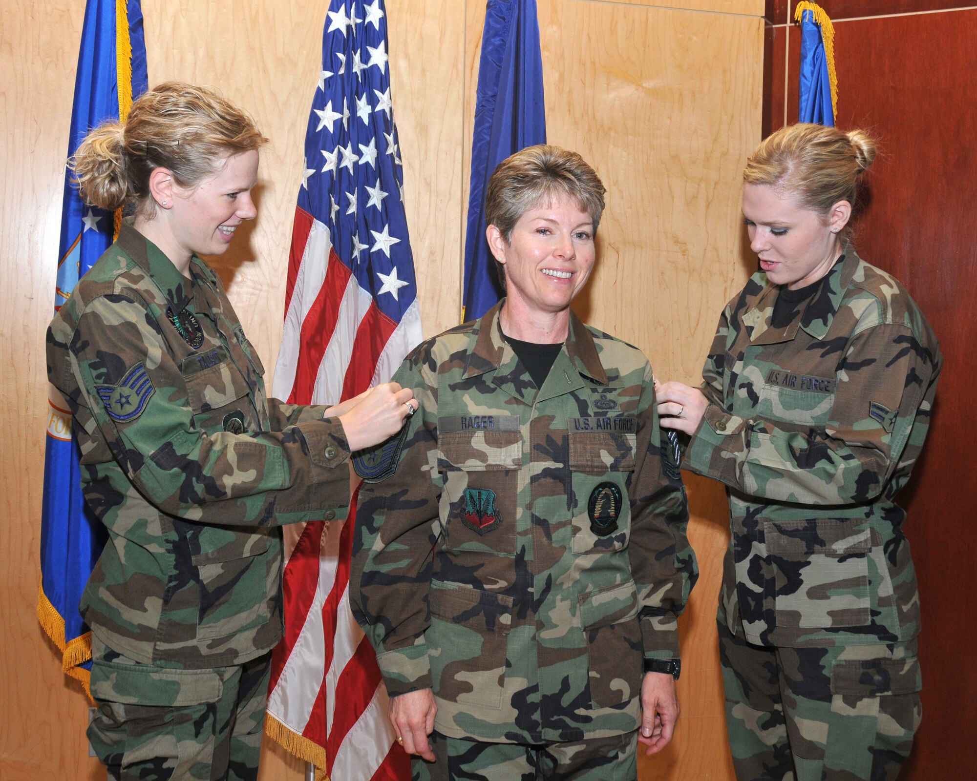 Staff Sergeant Erin B Nielsen and Airman First Class Ainslee E Rager-McIlwaine perform the pinning of her new rank of Chief Master First Sergeant stripes on the mother SMSgt Denise M Rager.  She is the new 151st Wing First Sergeant along with being the first CMS First Sergeant of the Utah Air National Guard.  Salt Lake City, Utah. November 2, 2008
(Released) U.S. Air Force photo by: Tech. Sgt. Michael D Evans
