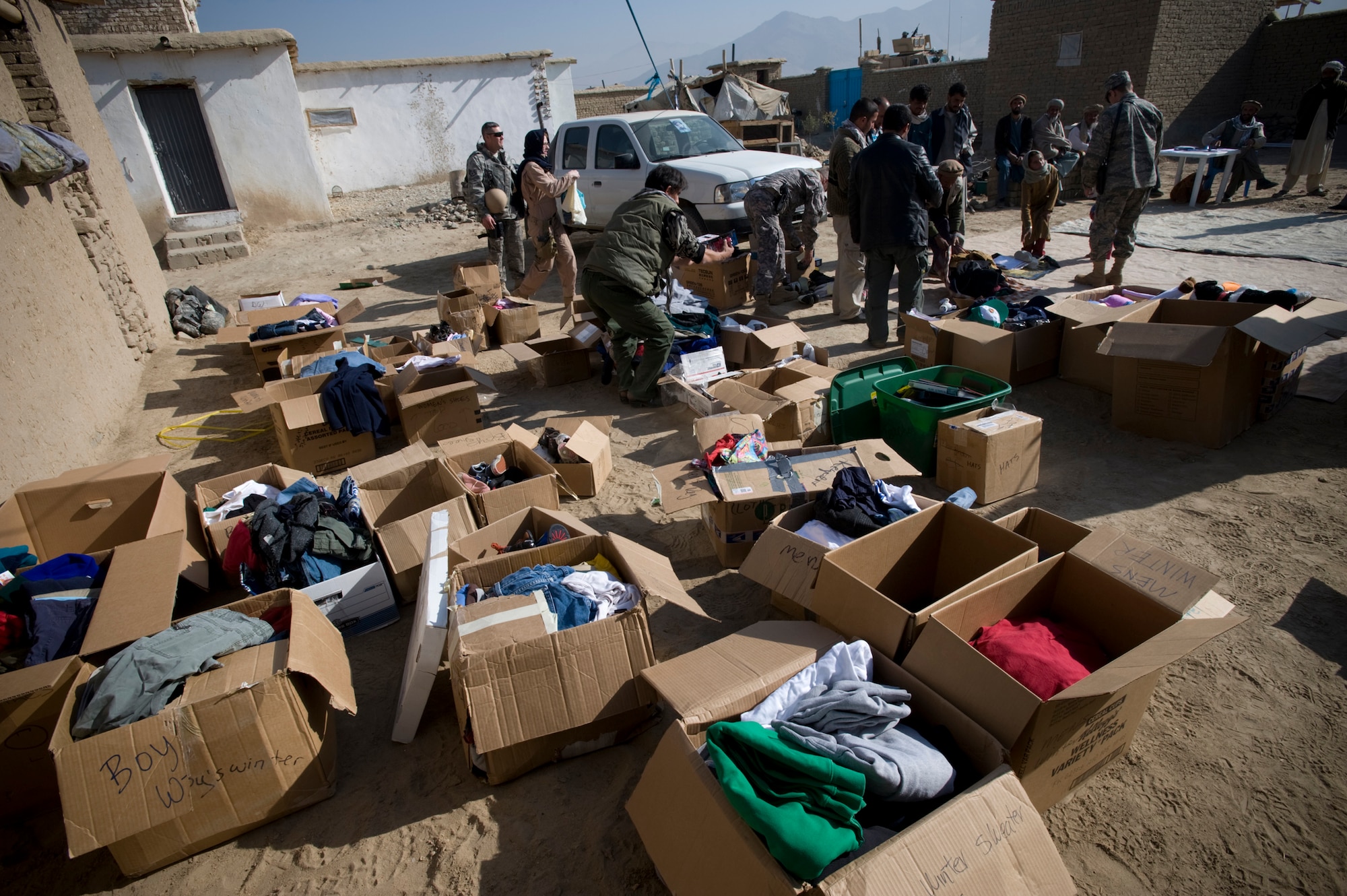 PARWAN REFUGEE CAMP, Afghanistan -- Clothes, shoes, coats, blankets, school supplies, toys and radios are organized for distribution during a humanitarian assistance visit here. The clothes and supplies where donated through Operation Care by American citizens. The Kapisa and Pawarn Provincial Reconstruction Team worked with the Afghan Department of Refugees and Reparation to coordinate the humanitarian assistance drop. The Parwan Refugee Camp is home to some of the poorest people in Afghanistan. (U.S. Air Force photo/Master Sgt. Keith Brown)
