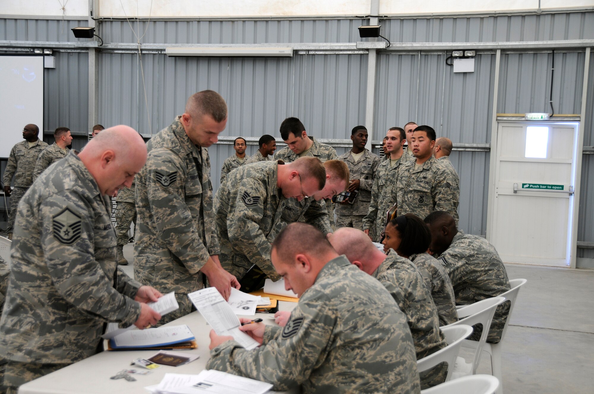 SOUTHWEST ASIA -- Members of the 380th Expeditionary Force Support Squadron process over 80 new Airmen here Nov.21. The PERSCO division's job is to ensure the transition happens as smoothly as possible.  (U.S. Air Force photo/Tech. Sgt. Christopher A. Campbell)(released)