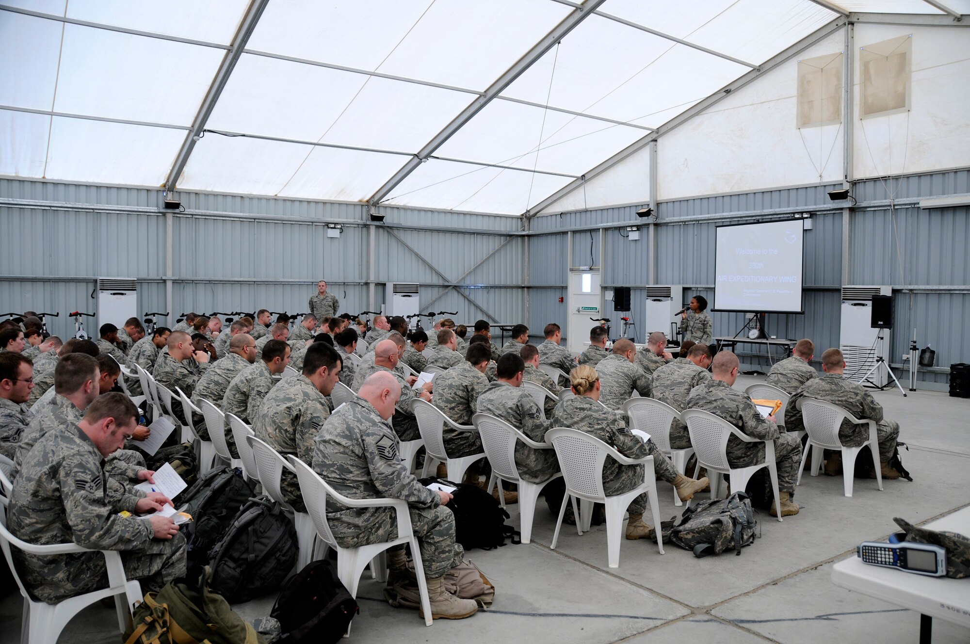 SOUTHWEST ASIA -- Senior Airman Stephanie Robinson from the 380th Expeditionary Force Support Squadron briefs personnel at their initial in-processing briefing here Nov. 21. PERSCO manages the transition every time with an initial briefing to ensure all paperwork is current and available, followed by a Warrior Brief with specific about the 380th. Airman Robinson is deployed from the 341st FSS, Malmstrom Air Force Base, Mont., her hometown is Eatonville, Wash. (U.S. Air Force photo/Tech. Sgt. Christopher A. Campbell)(released)