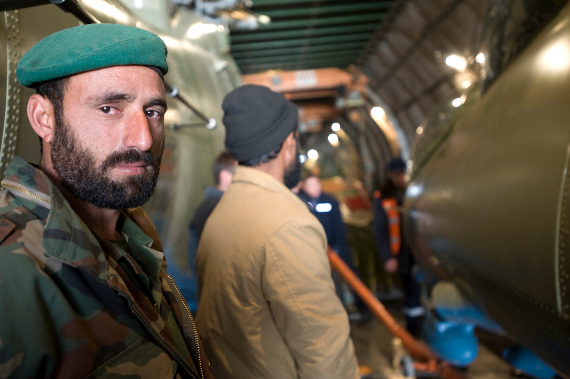 KABUL, Afghanistan -- An Afghan National Army Air Corps Airman waits to help unload parts for the three newly refurbished Mi-17 helicopters that arrived here on a AH-124 transport plane. The ANAAC is being mentored on all aspects of flying operations by Airman from the 438th Air Expeditionary Wing here.
(U.S. Air Force photo/Master Sgt. Keith Brown)