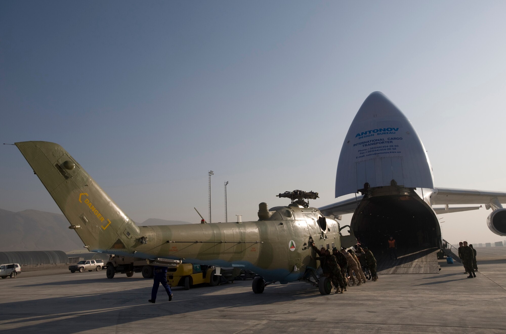 KABUL, Afghanistan -- An Mi-17 helicopter is unloaded from a AH-124 transport plane here. The three refurbished helicopters will be added to the Afghan National Army Air Corps fleet, helping the ANAAC conduct a larger portion of the airlift mission to support the Afghan National Army. The ANAAC is being mentored by Airman from the 438th Air Expeditionary Wing, stationed at Kabul. (U.S. Air Force photo/Master Sgt. Keith Brown)
