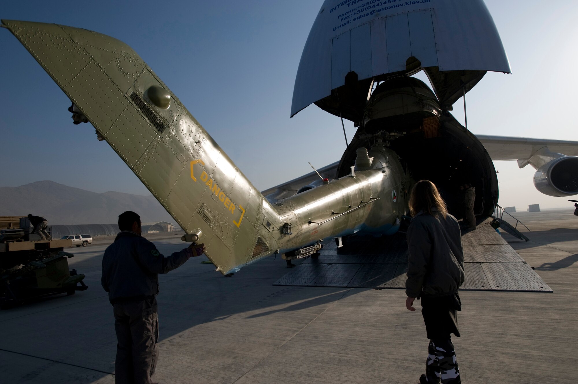 KABUL, Afghanistan -- An Mi-17 helicopter is unloaded from a AH-124 transport plane here. The three refurbished helicopters will be added to the Afghan National Army Air Corps fleet, helping the ANAAC conduct a larger portion of the airlift mission to support the Afghan National Army. The ANAAC is being mentored by Airman from the 438th Air Expeditionary Wing, stationed at Kabul. (U.S. Air Force photo/Master Sgt. Keith Brown)