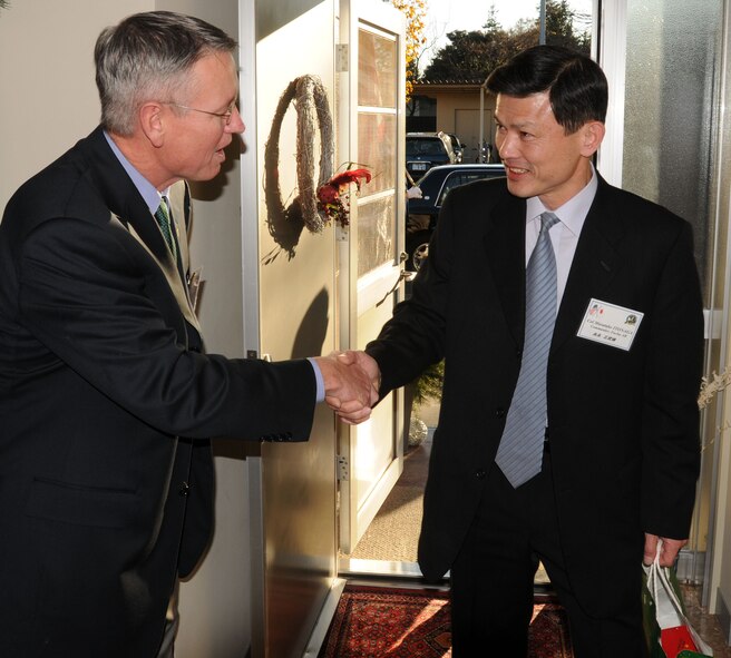 YOKOTA AIR BASE, Japan- Col. Jeff Newell, commander of the 374th Airlift Wing welcomes Col. Masatake Itonaga, commander of the Fuchu Air Base, to the holiday open house Dec. 7. (U.S. Air Force photo by. Amn Devin Doskey)