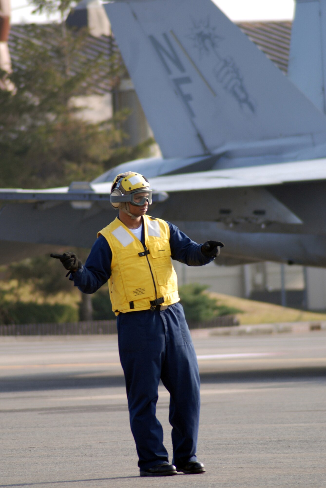 MISAWA AIR BASE, Japan -- Petty Officer 2nd Class Jason Williams, Naval Air Facility Misawa flight support crew member, directs the movement of an F/A-18E Super Hornet pilot prior to take-off. Four of the jets, from NAF Atsugi-based Strike Fighter Squadron 27, stopped at the base in Northern Japan as part of a routine training mission Dec. 4, 2008. (U.S. Navy photo by Chief Petty Officer Brian Naranjo)