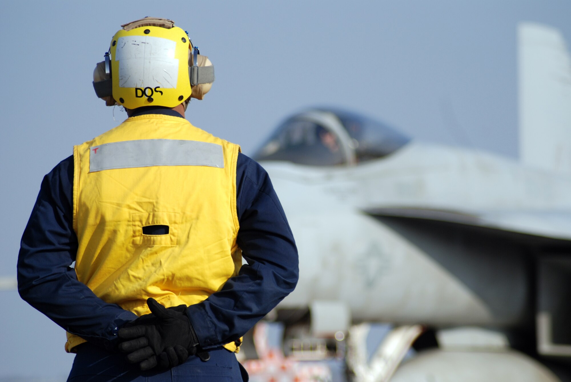 MISAWA AIR BASE, Japan -- Petty Officer 2nd Class Jason Williams, Naval Air Facility Misawa flight support crew member, prepares to direct the movement of an F/A-18E Super Hornet pilot prior to take-off. Four of the jets, from NAF Atsugi-based Strike Fighter Squadron 27, stopped at the base in Northern Japan as part of a routine training mission Dec. 4, 2008. (U.S. Navy photo by Chief Petty Officer Brian Naranjo)