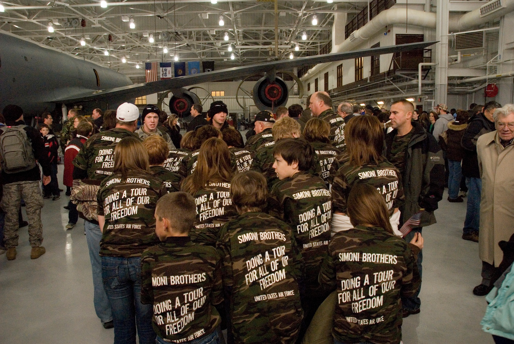 Senior Airman Mike and Airman 1st Class Andrew Simoni greet family and friends wearing t-shirts specially made to show their support of their military service.
Thirty Two Airmen from the 185th Air Refueling, Security Forces Squadron, Iowa Air National Guard in Sioux City, Iowa, return from a six month deployment on federal active duty, Sunday, December 7, 2008. 
The 185th Security Forces Squadron provided base security at Eskan Village, Saudi Arabia. These Airmen deployed as part of Operations Enduring Freedom, Iraqi Freedom and the Global War on Terror. 
Official Air Force Photo by: SSgt. Oscar M. Sanchez-Alvarez
