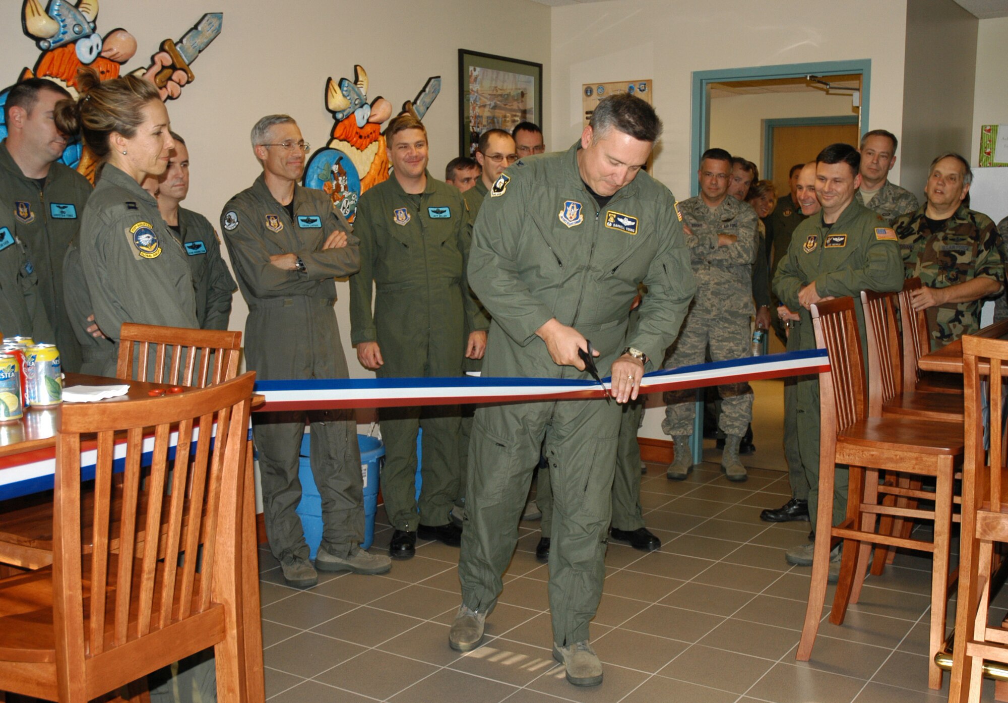 Col. Darrell Young, 512th Operations Group commander, officially cuts the ribbon to the new 512th OG heritage room during the November UTA. The room is the first in the history of the 512th Airlift Wing flyers.                             