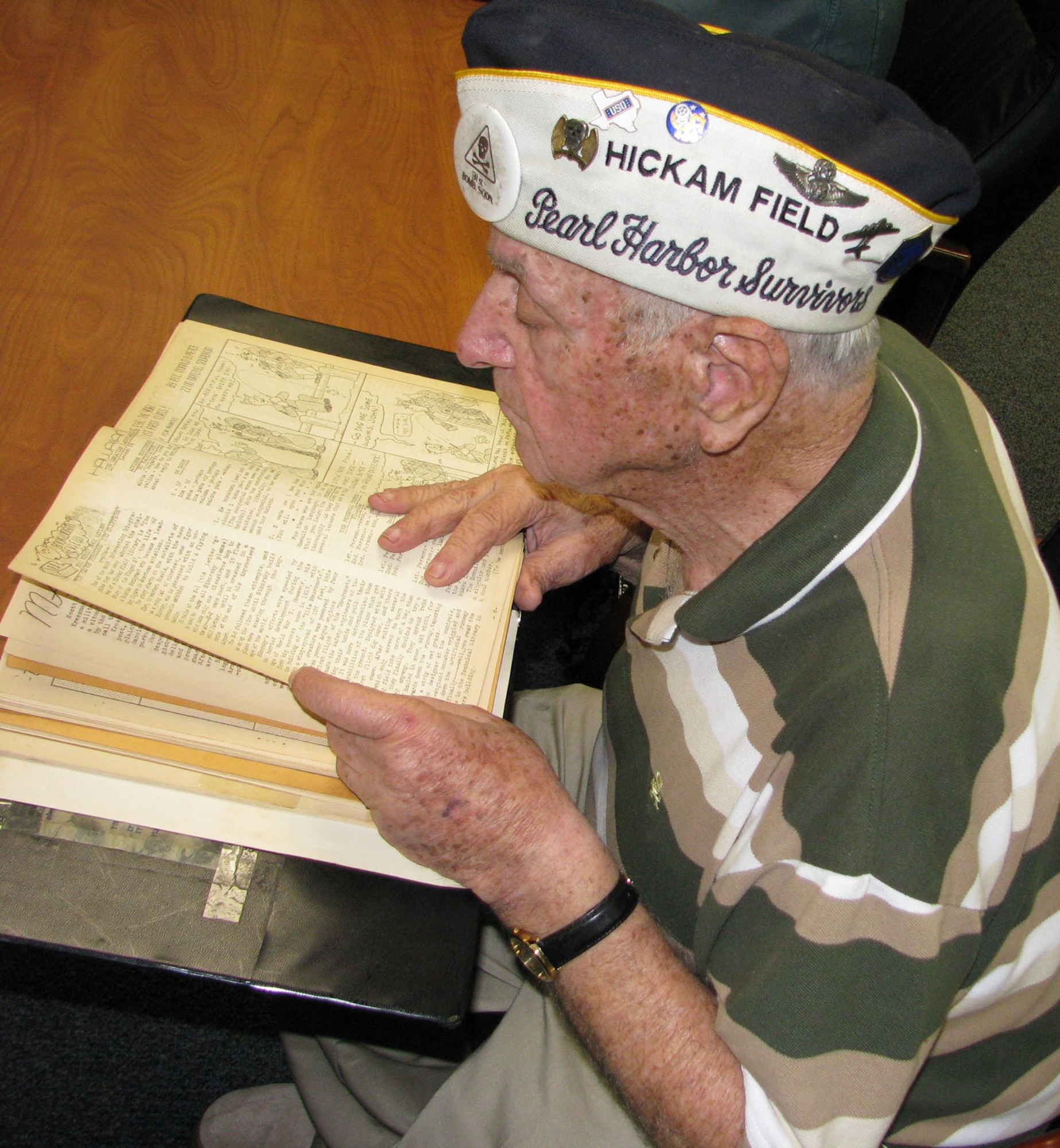 (Dec. 5, 2008) Air Force retired Senior Master Sergeant., and Dec. 7, 1941 Hickam Field Survivor, Lou Roffman looks over old newsletters from the 31st Bombardment Squadron.  Roffman and other Hickam Field Survivors returned to Hickam Air Force Base to be part of various remembrance events that concluded with a remembrance ceremony Sunday morning.  Roffman was a B-17 flight engineer stationed at Hickam Field when it was attacked.  (U.S. Air Force Photo/Dr. Philip Breeze)