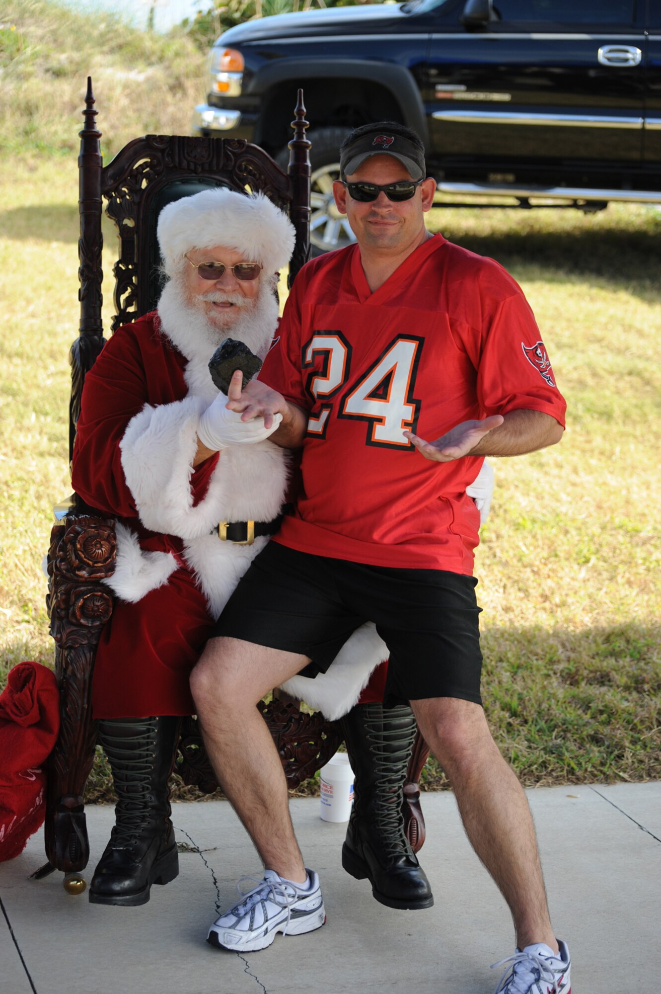 PATRICK AIR FORCE BASE, Fla. -- Air Force Reserve Master Sgt. Stephen Richmond, Weapons Safety Manager for the 920th Rescue Wing, receives a lump of coal from Santa Claus during the wing's holiday picnic December 6 at the north picnic area.  photo/Master Sgt. Ray Padgett