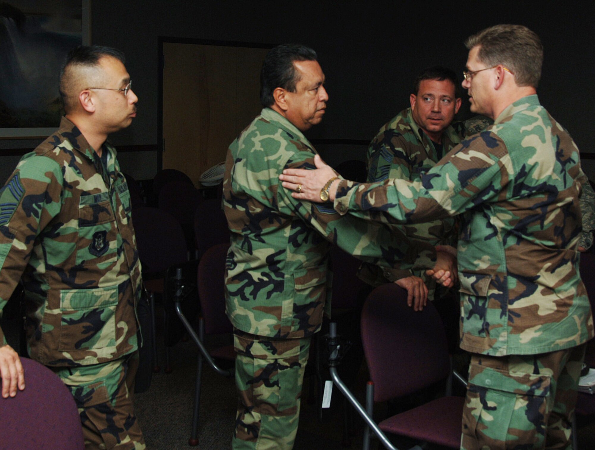 Lt. Col. Jeff Pickard (far right) thanks Chief Master Sgt. Carlos Rivas for helping plan growth within the 931st Air Refueling Group. Chief Rivas and Chief Master Sgt. Jing Moy (far left) were part of a site acivation task force that arrived at McConnell Air Force Base, Kan., on Dec. 2 for three days of meetings. Colonel Pickard is commander of the 931st's maintenance squadron. The 931st ARG is an Air Force Reserve unit at McConnell AFB (U.S. Air Force photo/Tech. Sgt. Jason Schaap)