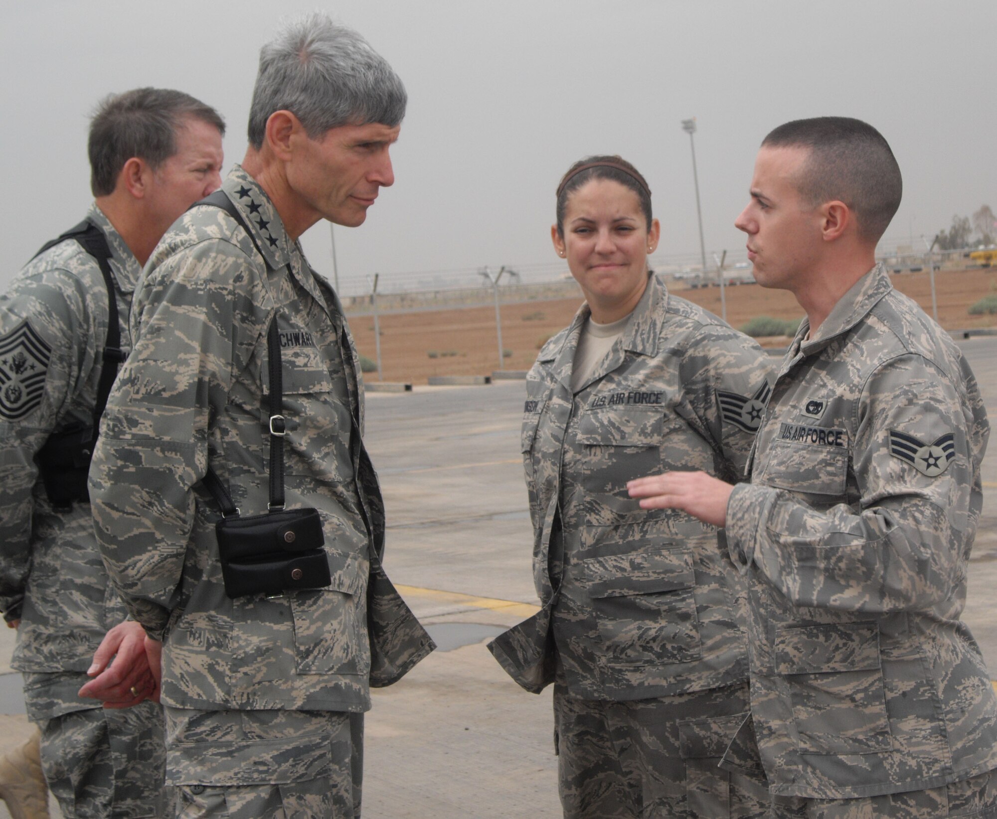 Senior Airman Matthew Dauphinais talks with Air Force Chief of Staff Gen. Norton Schwartz and Chief Master Sgt. of the Air Force Rodney McKinley at a deployed location in Iraq. (Courtesy photo)