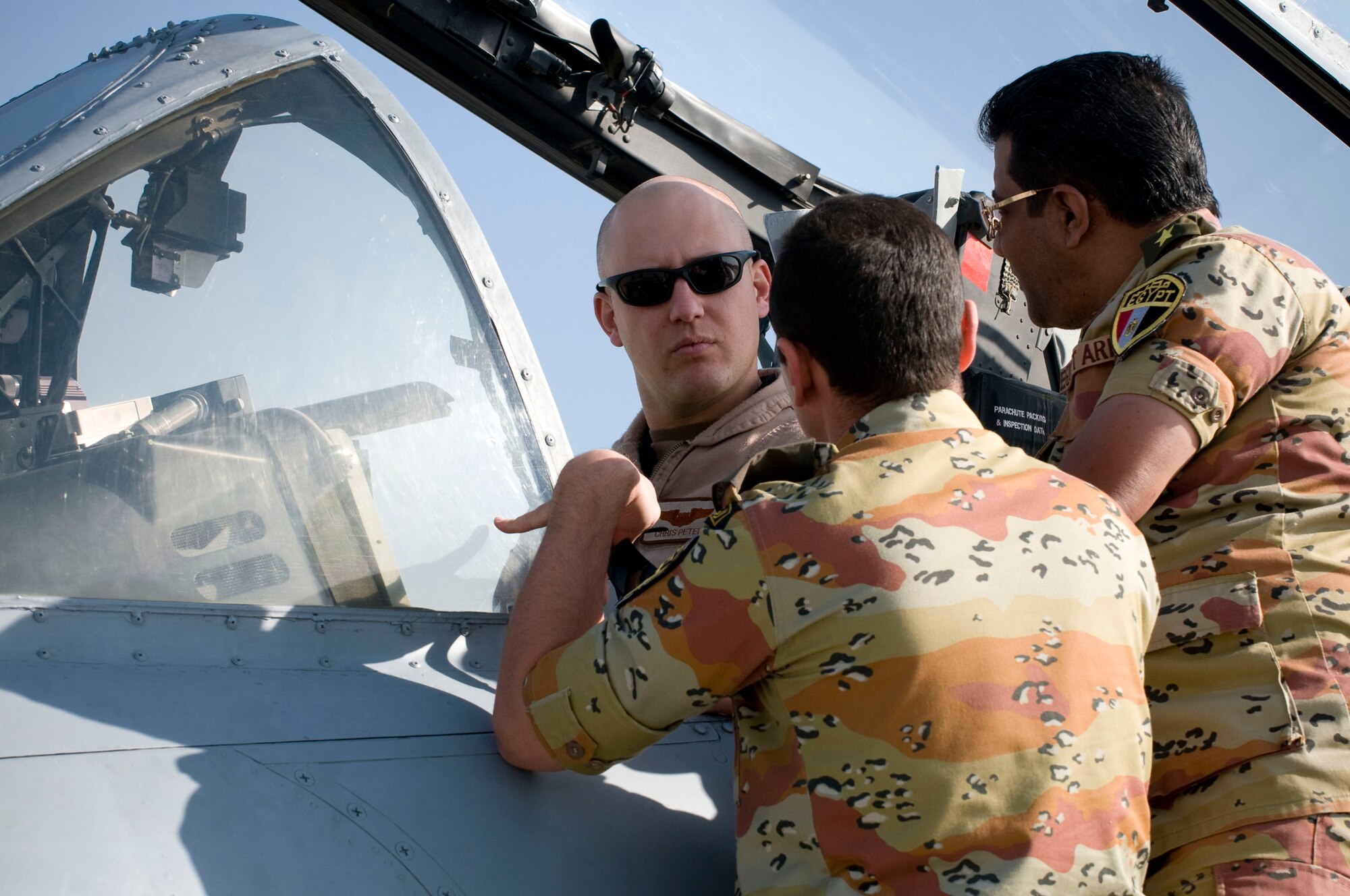Capt. Chris Petek shows two Egyptian medical personnel the cockpit of an A-10 Thunderbolt II at Bagram Air Field, Afghanistan, Nov. 29. The Egyptian commander, Commander Mohamad, was impressed with capabilities of the American fighter jets. Captain Petek is deployed from the 75th Fighter Squadron, Moody Air Force Base, Ga., and hails from Bigfork, Mont. (U.S. Air Force photo by Staff Sgt. Samuel Morse)(Released)