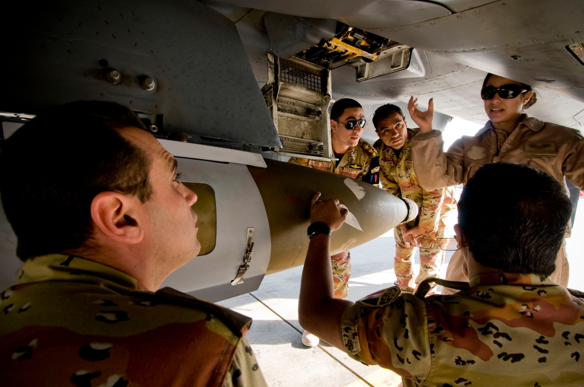 An F-15E Strike Eagle weapons systems officer explains the role of the F-15E's machine gun to a group of Egyptian medical personnel at Bagram Air Field, Afghanistan, Nov. 29. Being from Egyptian descent, the WSO was able to give most the tour in Arabic, avoiding any potential language barriers. (U.S. Air Force photo by Staff Sgt. Samuel Morse) (Released)