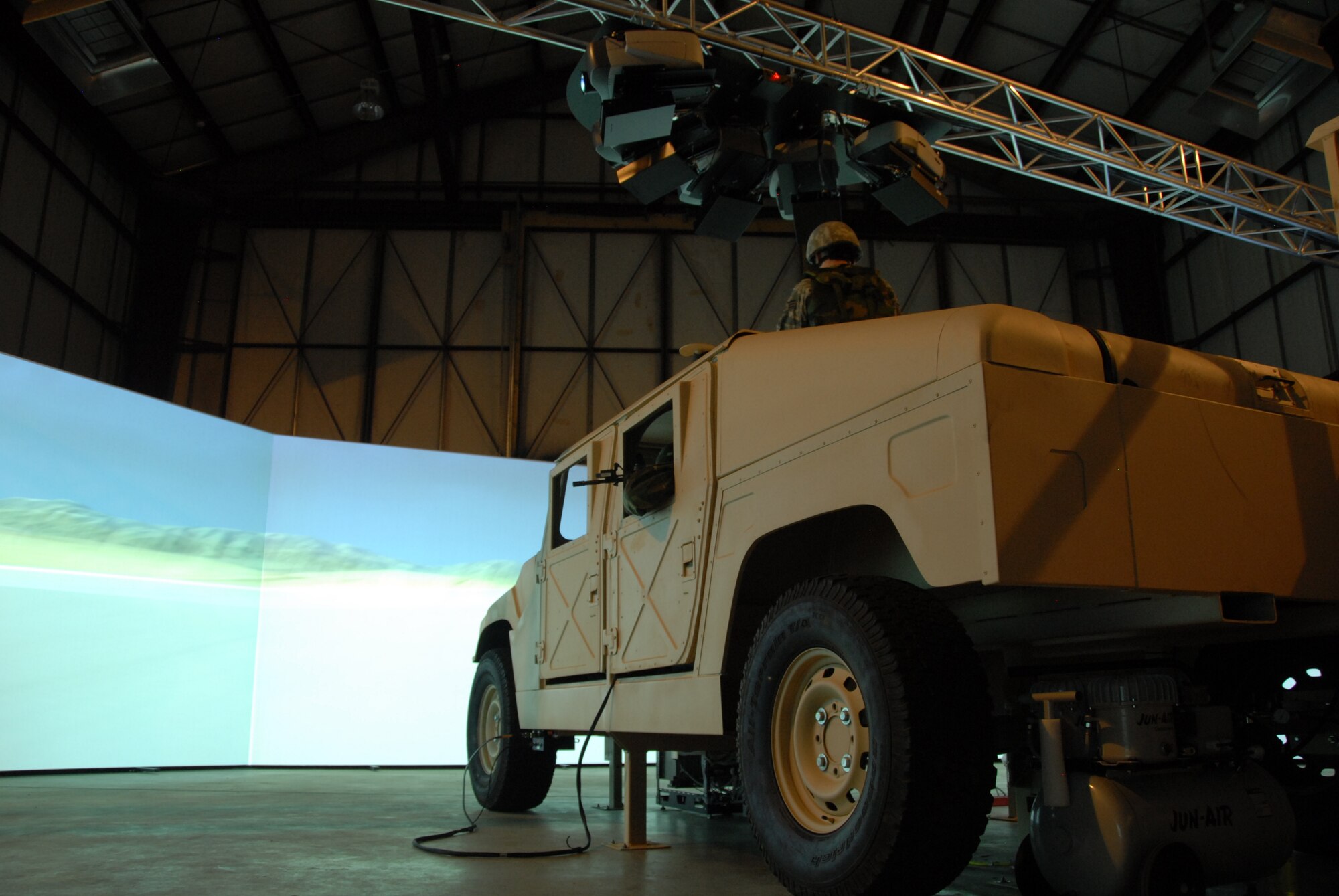 Much like an IMAX, a 280 degree screen brings to life real world scenarios
designed to put a four-person fire team made up of a driver, gunner, rifleman and
troop commander through the paces of an actual convoy mission. (U.S. Air Force
photo by Master Sgt. Dan Richardson.)