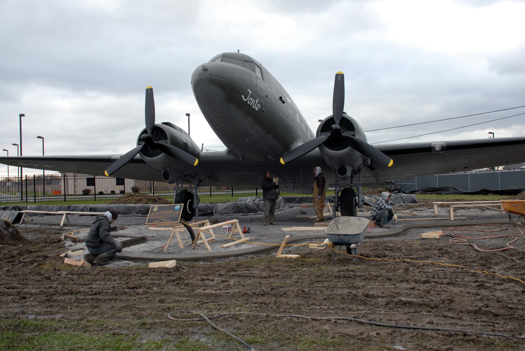 NIAGARA FALLS AIR RESERVE STATION, N.Y. -- Contract workers perform construction work around static display aircraft here. A cement curb and pad is being poured to protect the aircraft.  The curbs will be completed this year and the pads will be poured weather permitting.  The curbs after being poured are covered with heating blankets until the cement cures.  The aircraft are on loan from the National Museum United States Air Force. It is the base's responsibility to maintain display aircraft and to report on their condition annually.  (U.S. Air Force photo by Staff Sgt. Joseph McKee)