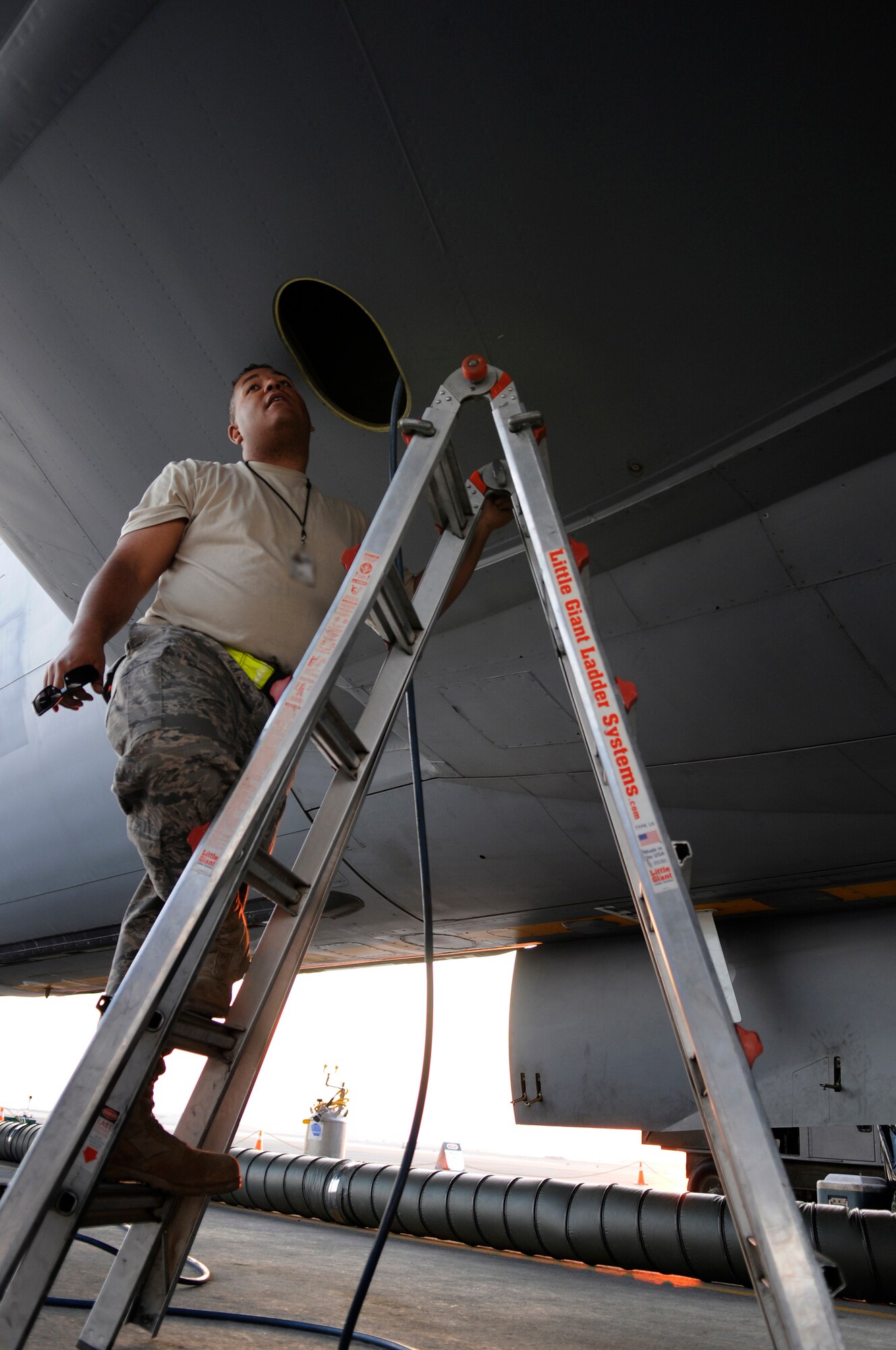 Staff Sgt. Eric Holmes, a fuels system craftsman assigned to the 379th Expeditionary Maintenance Squadron, provides technical advice to his fuels system journeyman doing repairs inside a KC-135 Stratotanker left center wing integral tank, Dec. 5, at an undisclosed air base in Southwest Asia.  After the repair is complete Sergeant Holmes will climb inside and complete a quality control check on the repairs.  Sergeant Holmes, a native of Brandon Fla., is deployed from McConnell Air Force Base, Kan., in support of Operations Iraqi and Enduring Freedom and Joint Task Force-Horn of Africa.  (U.S. Air Force photo by Tech. Sgt. Michael Boquette/Released)