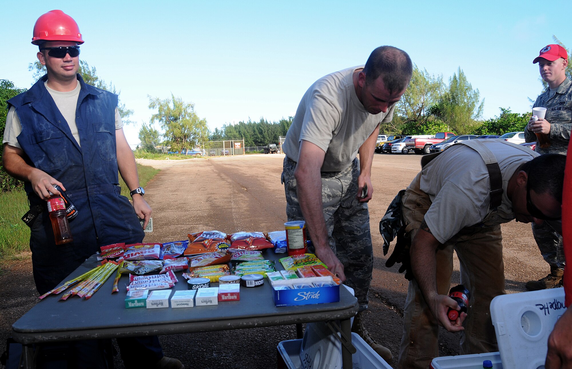 ANDERSEN AFB, Guam - 554th REDHORSE Airmen purchase items at a "mini shopette" at Northwest Field on Dec. 5.  Army Air Force Exchange Service shopette employees have been providing the service for more than three weeks to alleviate time lost to the mission from Airmen having to drive 30 minutes to the local market.   (U.S. Air Force photo by Staff Sgt. Jamie Lessard)  